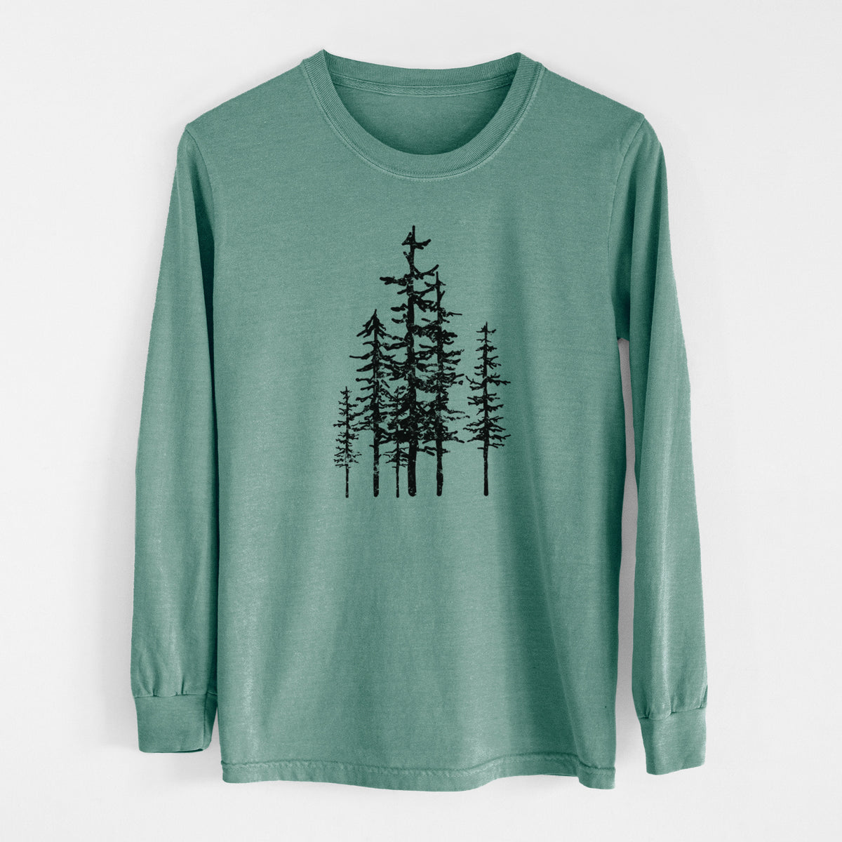 Pine green Comfort Colors long sleeve shirt laid flat, printed with a black ink illustration of a cluster of evergreen trees of varying heights.