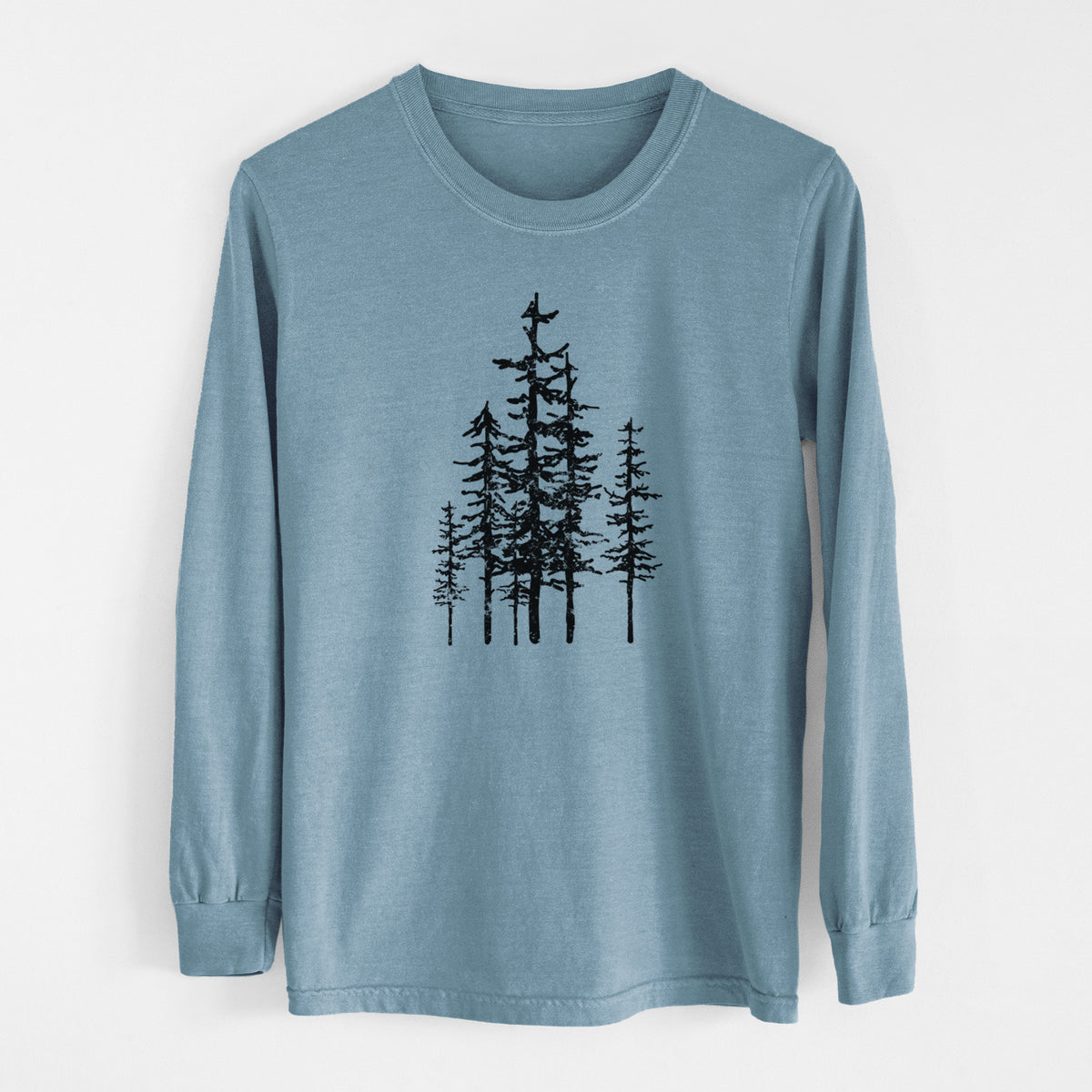 Steel blue Comfort Colors long sleeve shirt laid flat, printed with a black ink illustration of a cluster of evergreen trees of varying heights.