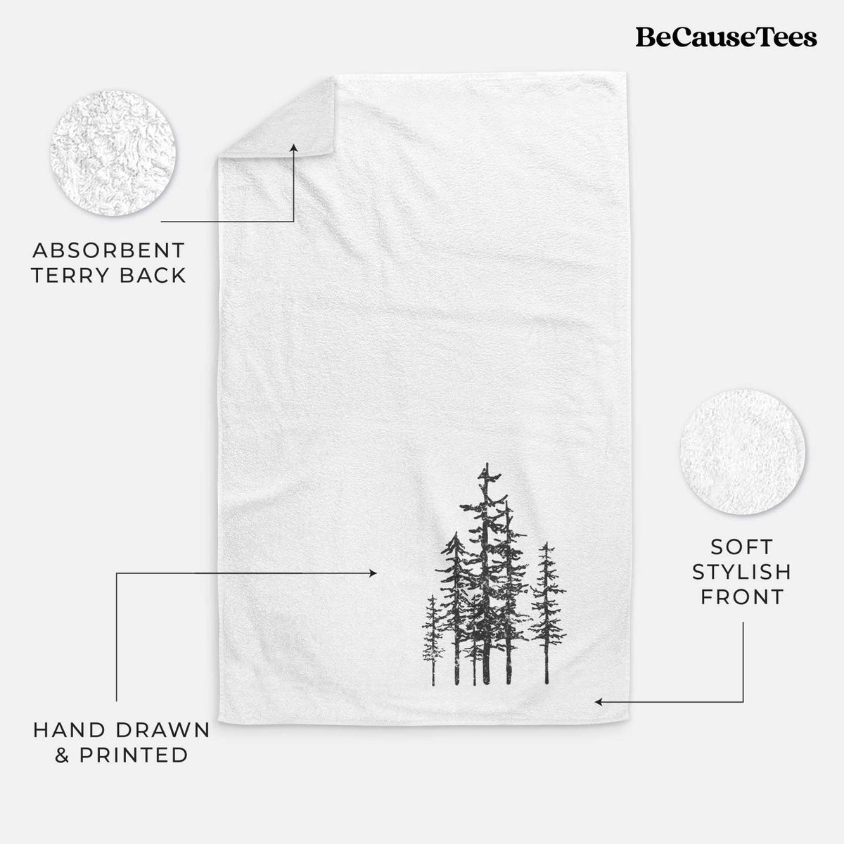 White hand towel printed with a black ink illustration of a cluster of evergreen trees of varying heights.