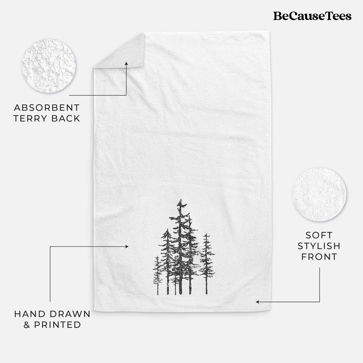 White hand towel printed with a black ink illustration of a cluster of evergreen trees of varying heights.