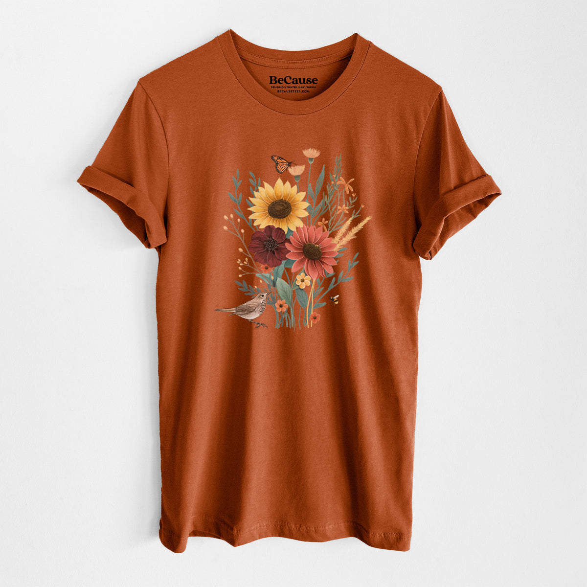 Autumn lightweight cotton t-shirt laid flat, printed with a full-color bouquet of sunflowers, red flowers and wildflowers with butterflies and a small bird.