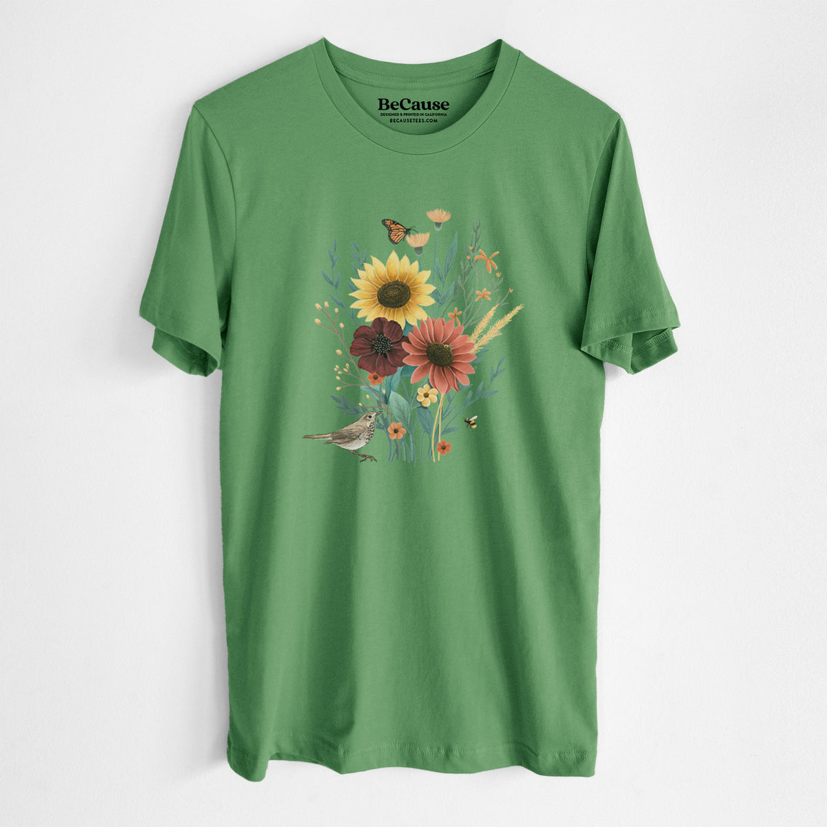 Leaf green lightweight cotton t-shirt laid flat, printed with a full-color bouquet of sunflowers, red flowers and wildflowers with butterflies and a small bird.