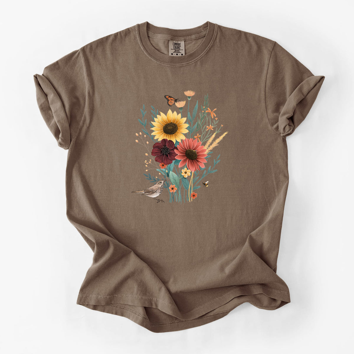 Espresso brown Comfort Colors t-shirt laid flat, printed with a full-color bouquet of sunflowers, red flowers and wildflowers with butterflies and a small bird.