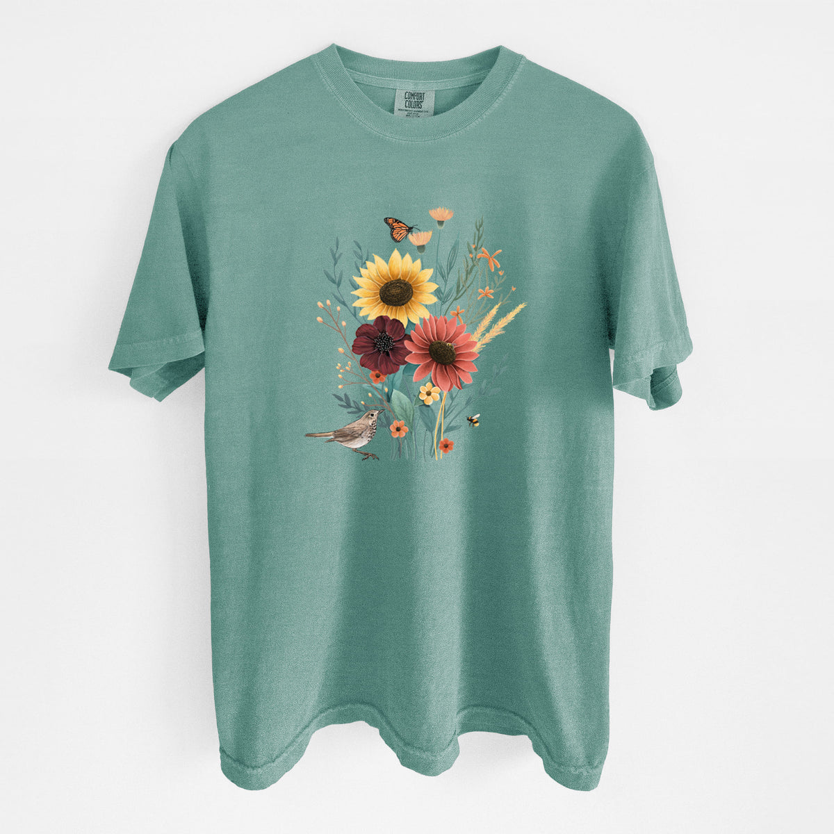 Reef green Comfort Colors t-shirt laid flat, printed with a full-color bouquet of sunflowers, red flowers and wildflowers with butterflies and a small bird.