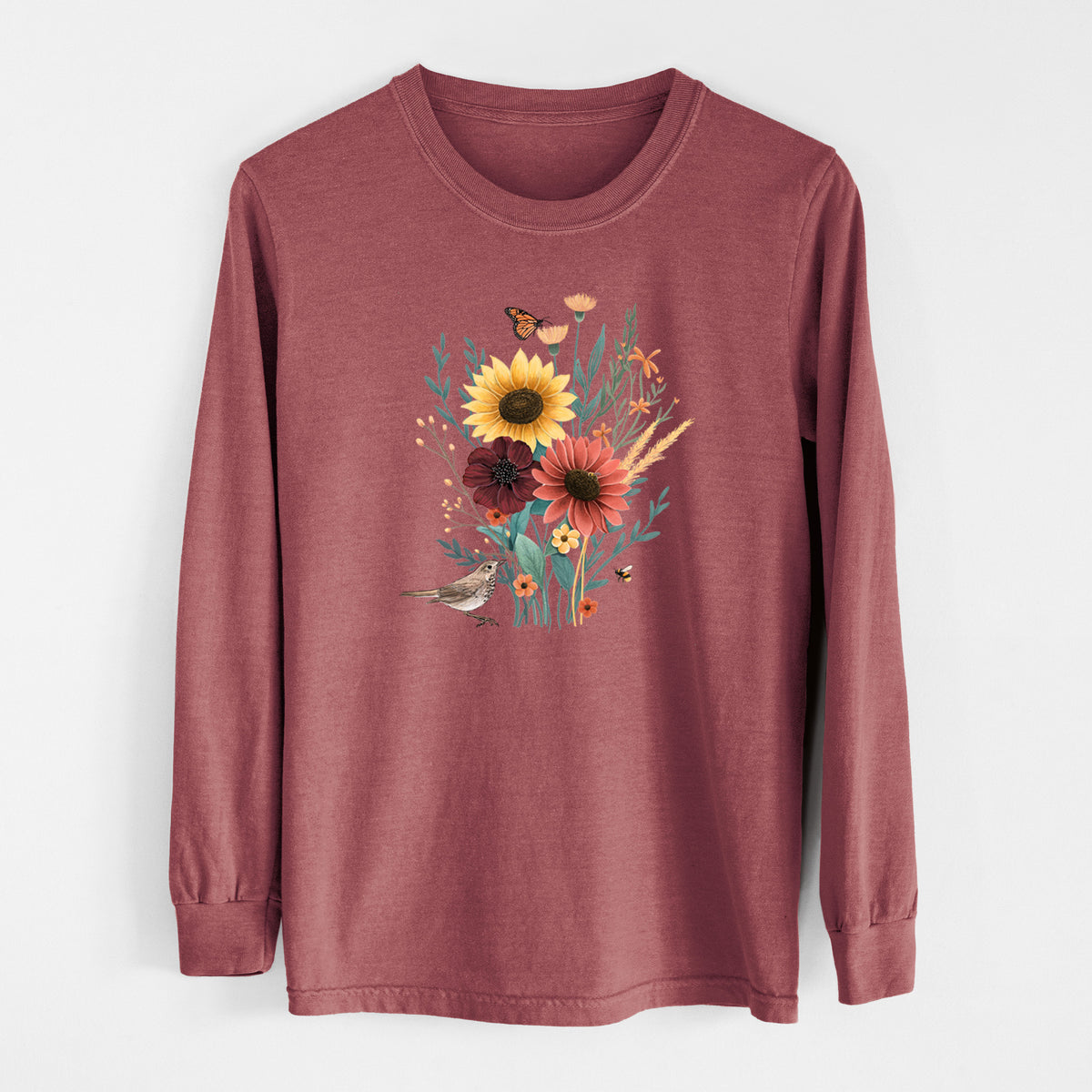 Brick red Comfort Colors long sleeve shirt laid flat, printed with a full-color bouquet of sunflowers, red flowers and wildflowers with butterflies and a small bird.