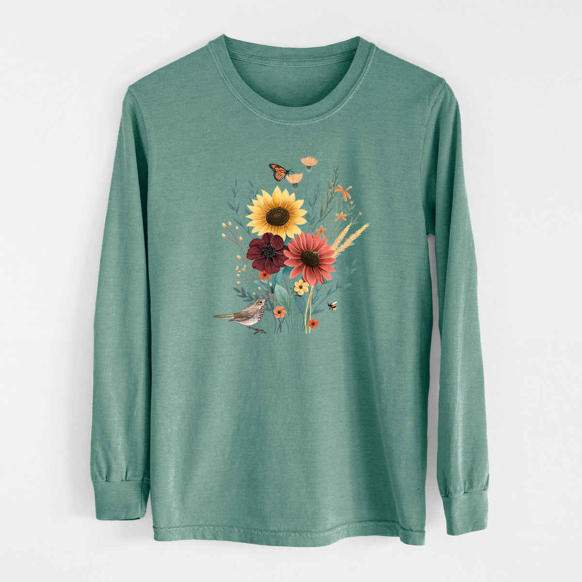 Pine green Comfort Colors long sleeve shirt laid flat, printed with a full-color bouquet of sunflowers, red flowers and wildflowers with butterflies and a small bird.