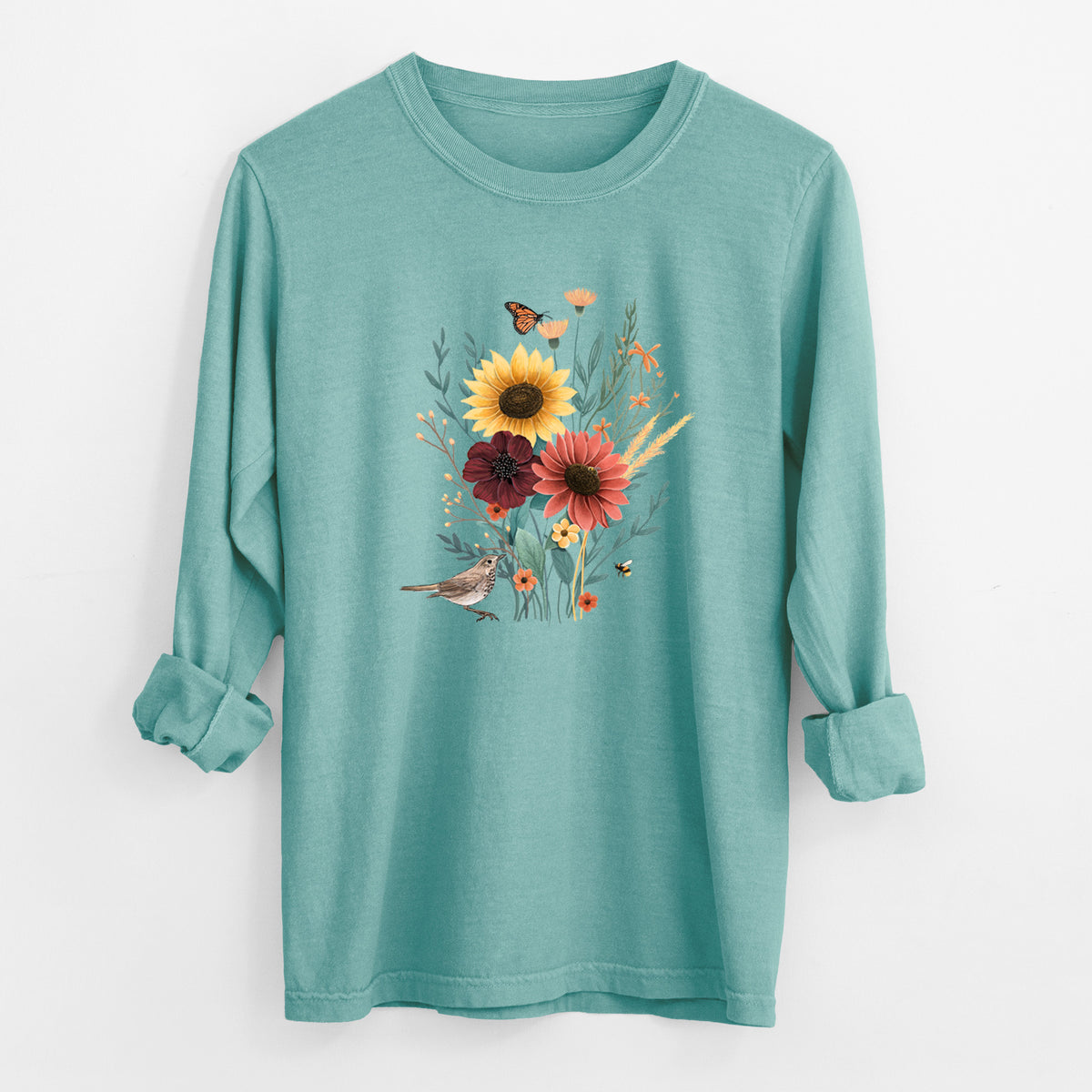 Reef green Comfort Colors long sleeve shirt laid flat with the cuffs rolled, printed with a full-color bouquet of sunflowers, red flowers and wildflowers with butterflies and a small bird.
