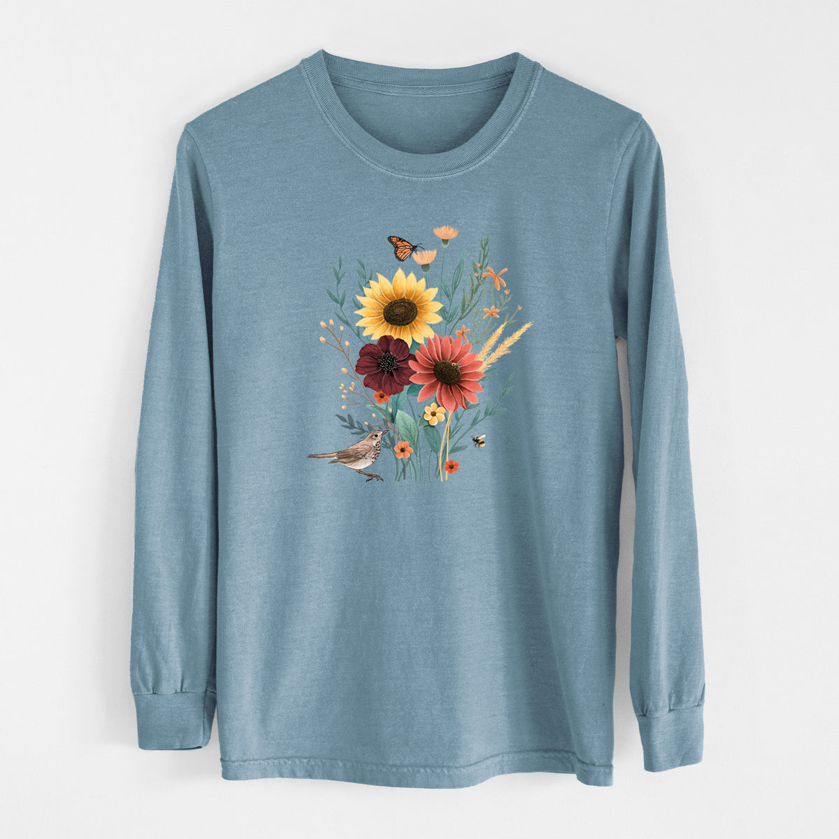 Steel blue Comfort Colors long sleeve shirt laid flat, printed with a full-color bouquet of sunflowers, red flowers and wildflowers with butterflies and a small bird.
