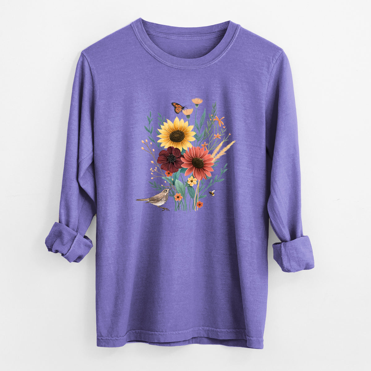 Violet purple Comfort Colors long sleeve shirt laid flat with the cuffs rolled, printed with a full-color bouquet of sunflowers, red flowers and wildflowers with butterflies and a small bird.