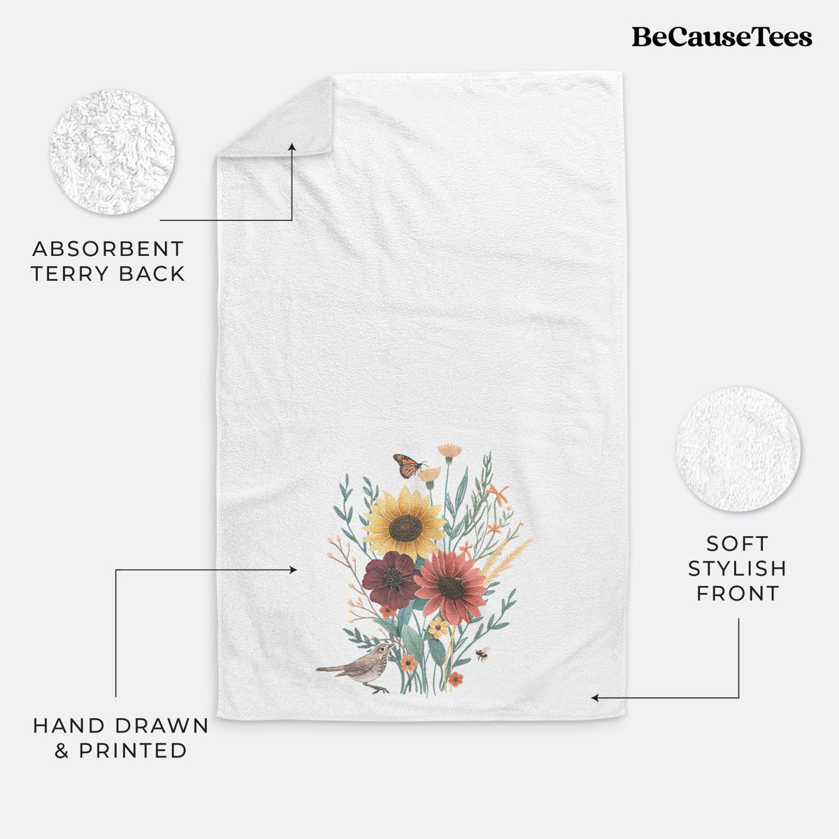 White hand towel printed with a full-color bouquet of sunflowers, red flowers and wildflowers with butterflies and a small bird.