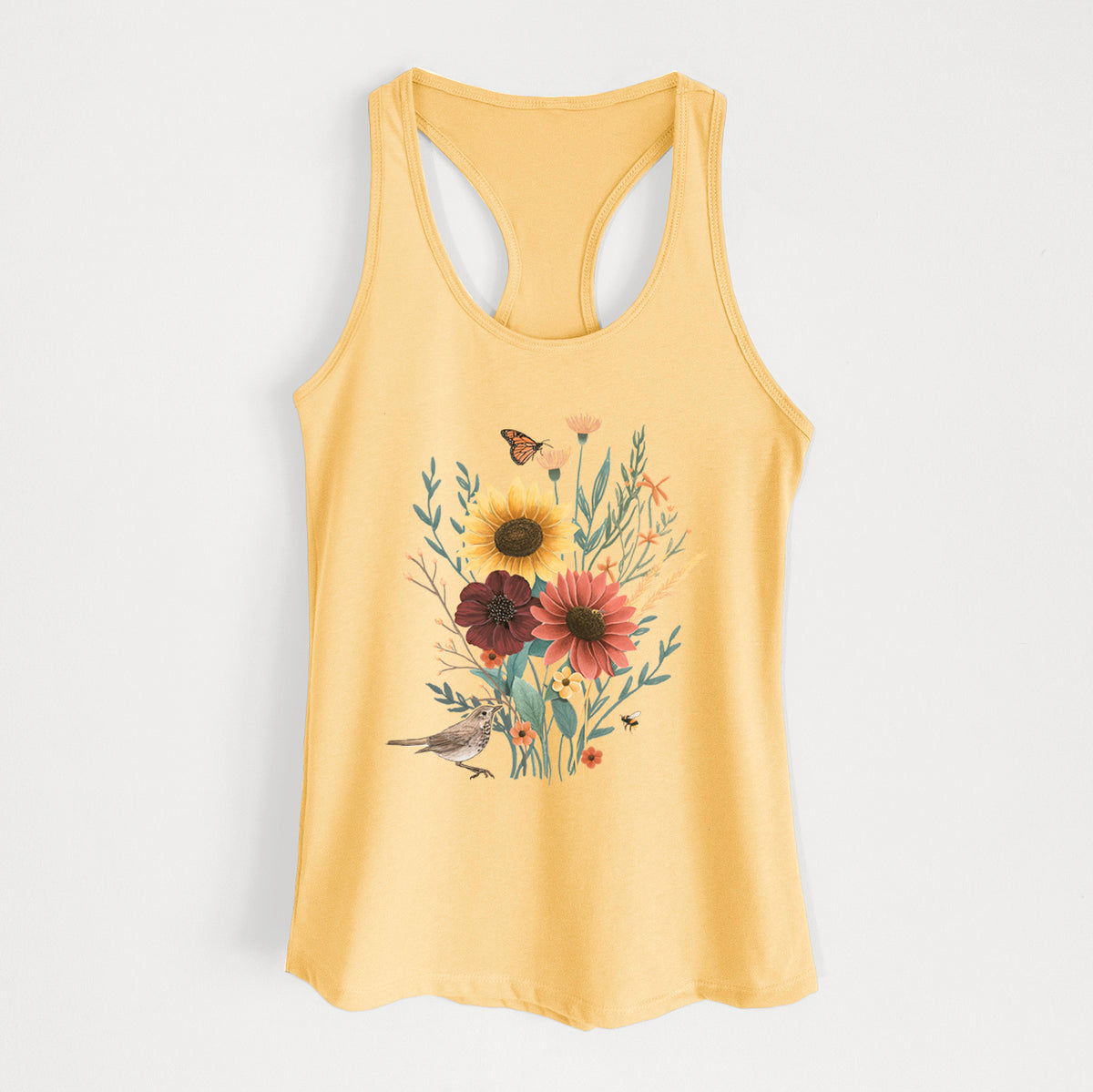 Banana cream women's racerback tank top laid flat, printed with a full-color bouquet of sunflowers, red flowers and wildflowers with butterflies and a small bird.