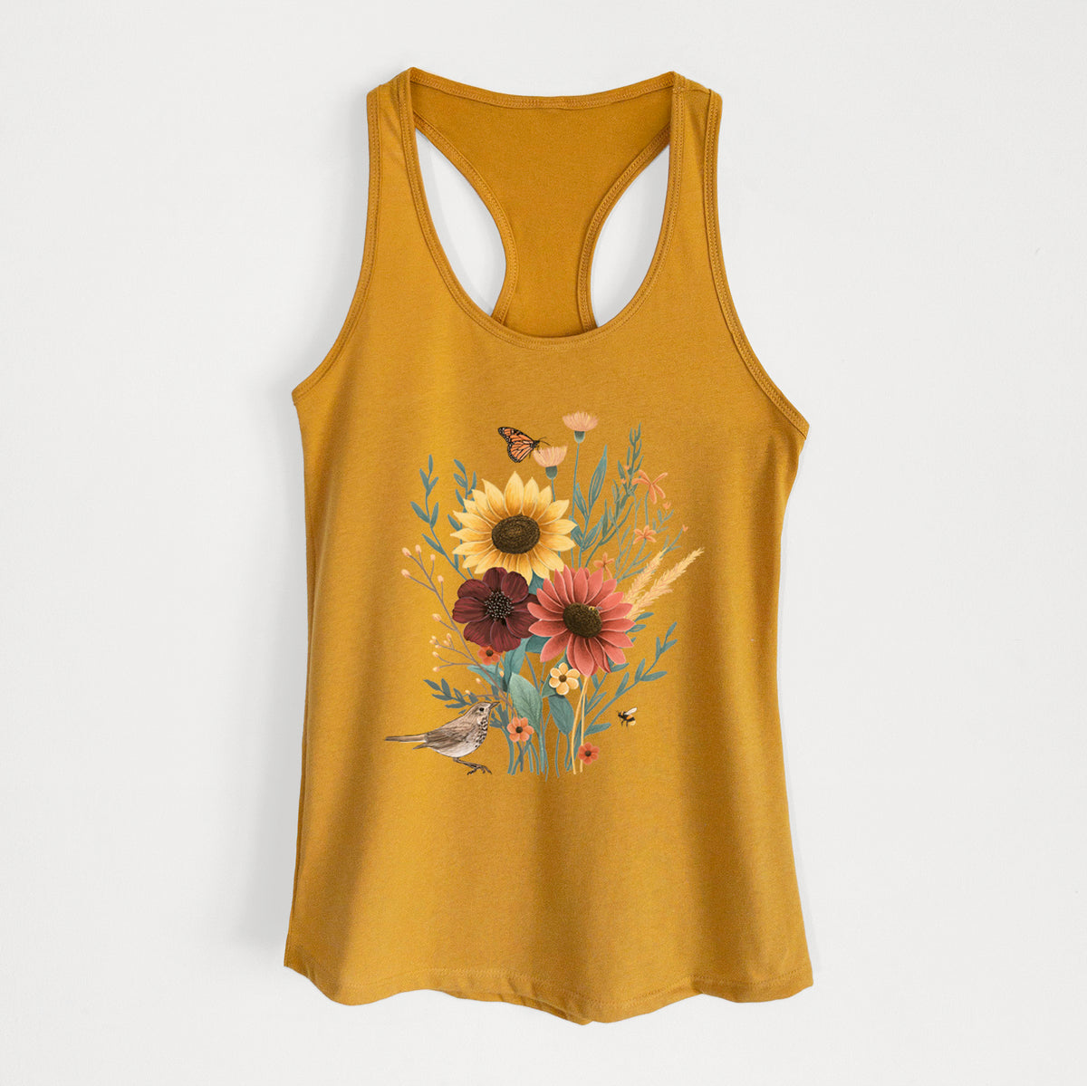 Gold women's racerback tank top laid flat, printed with a full-color bouquet of sunflowers, red flowers and wildflowers with butterflies and a small bird.
