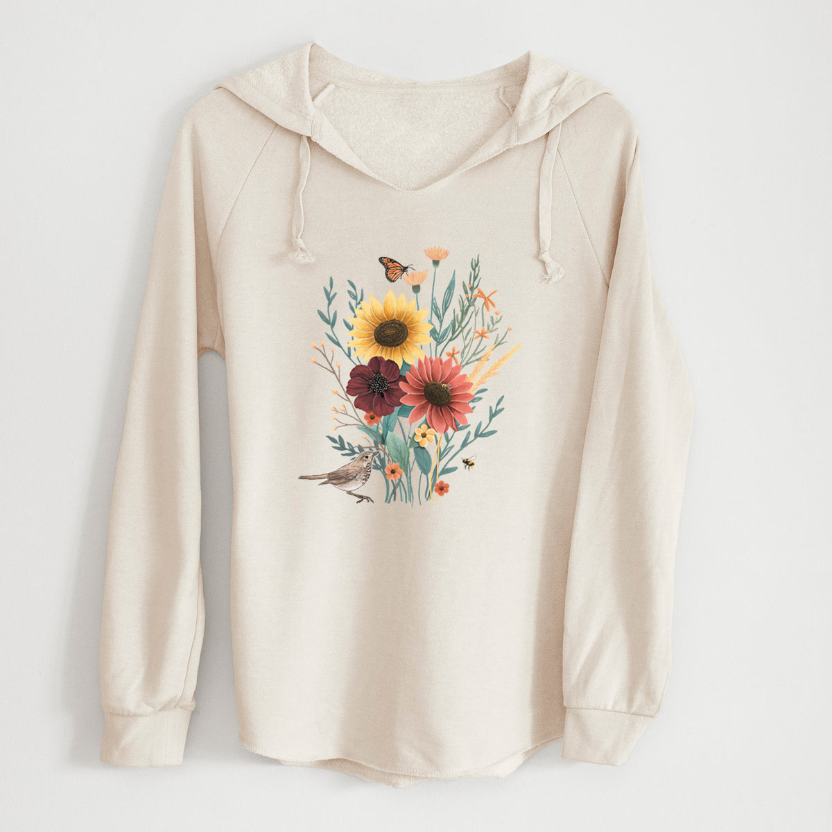 Bone cream women's Cali Wave hooded sweatshirt laid flat, printed with a full-color bouquet of sunflowers, red flowers and wildflowers with butterflies and a small bird.