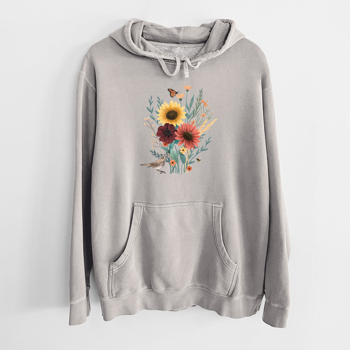 Cement grey pigment dyed hoodie laid flat, printed with a full-color bouquet of sunflowers, red flowers and wildflowers with butterflies and a small bird.