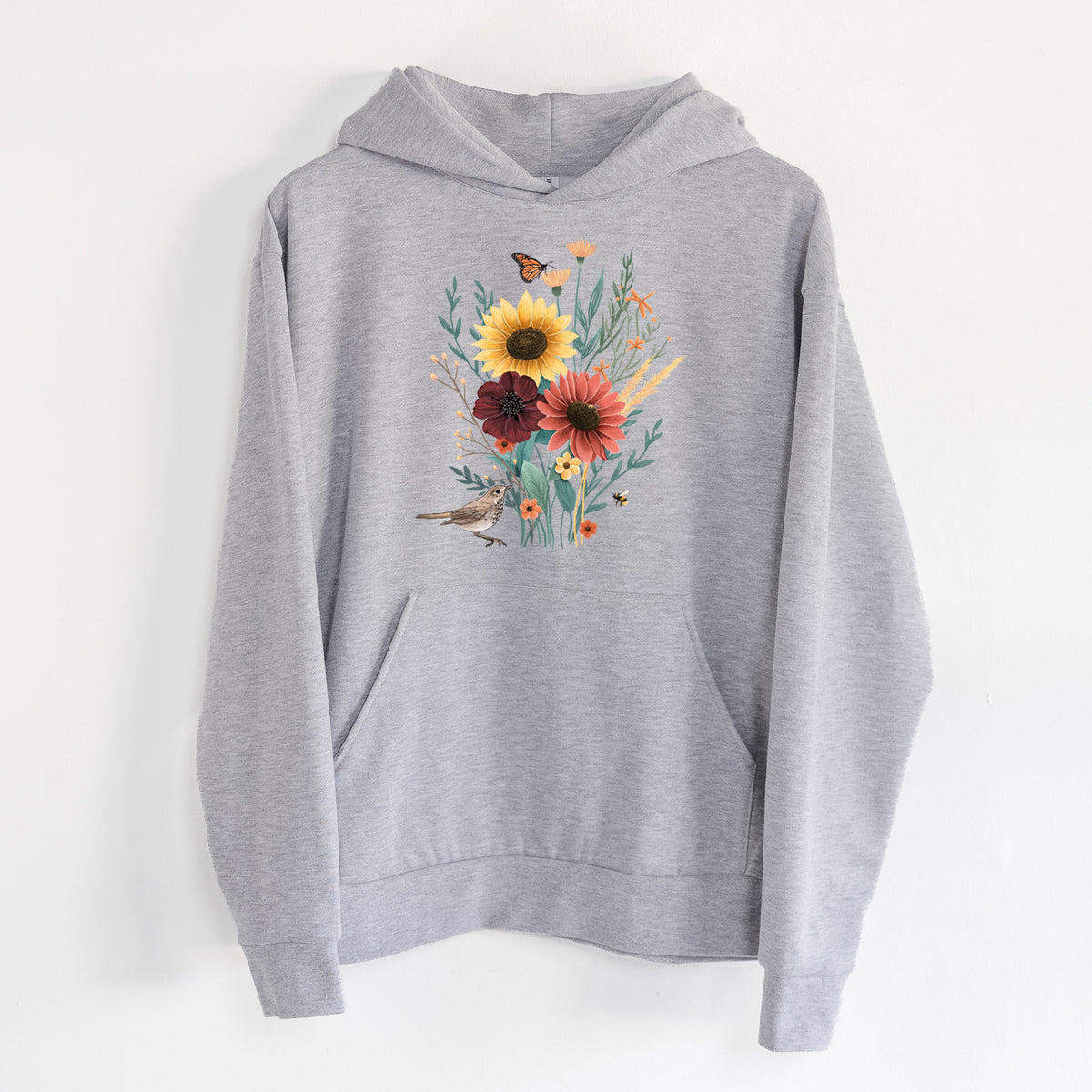 Fall Bouquet - Statement Midweight Hoodie in Heather Grey, hanging on a white wall, with a front kangaroo pocket and no drawcords.