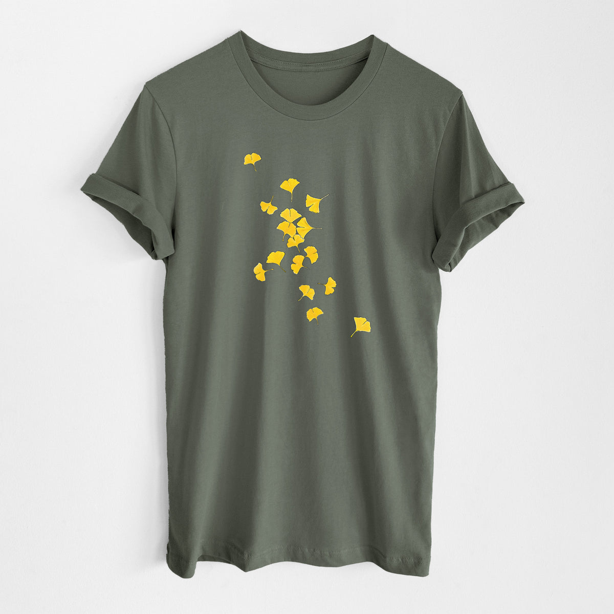 Military green lightweight cotton t-shirt laid flat, printed with a scatter of bright yellow fan-shaped ginkgo leaves falling.