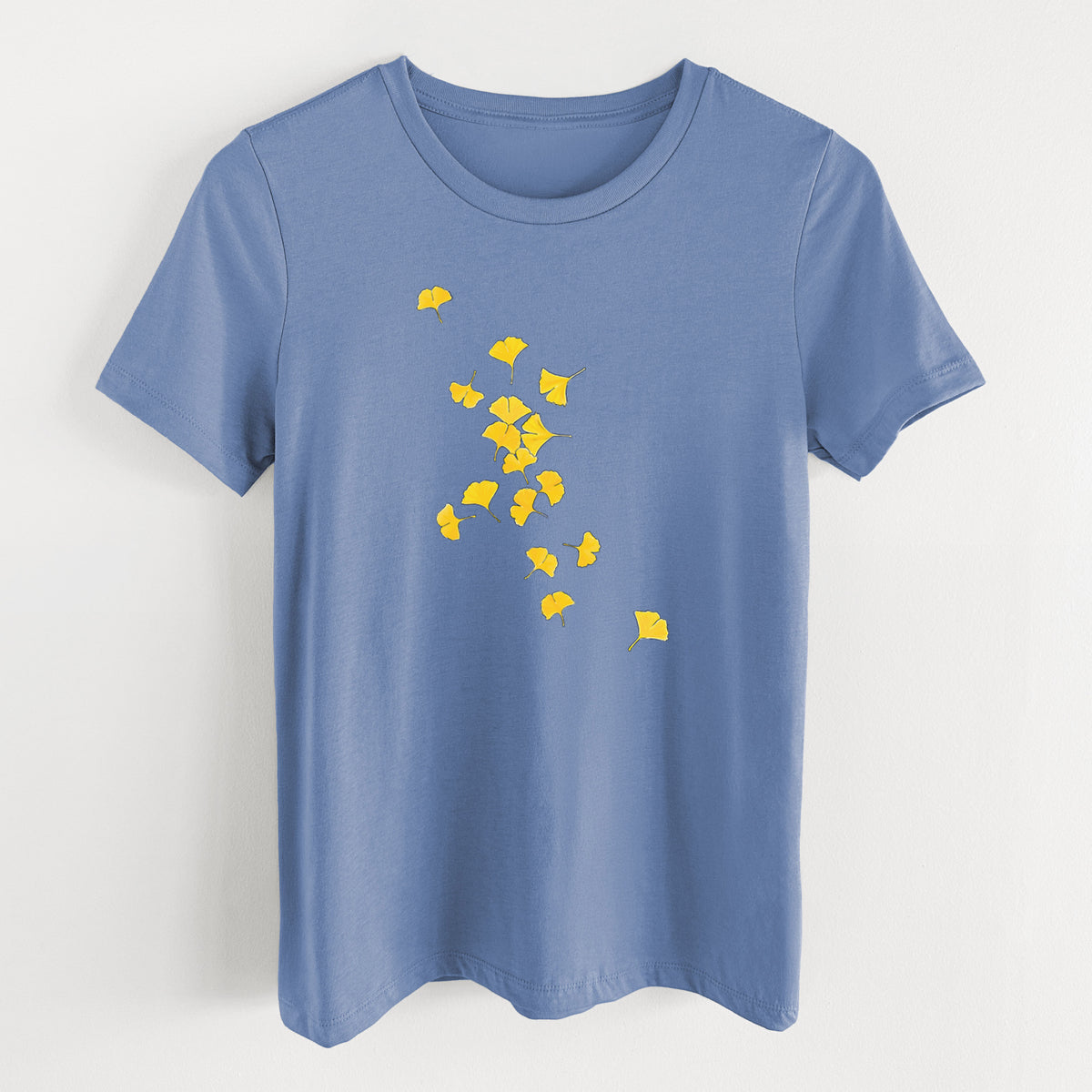 Blue bell women's relaxed fit cotton t-shirt laid flat, printed with a scatter of bright yellow fan-shaped ginkgo leaves falling.