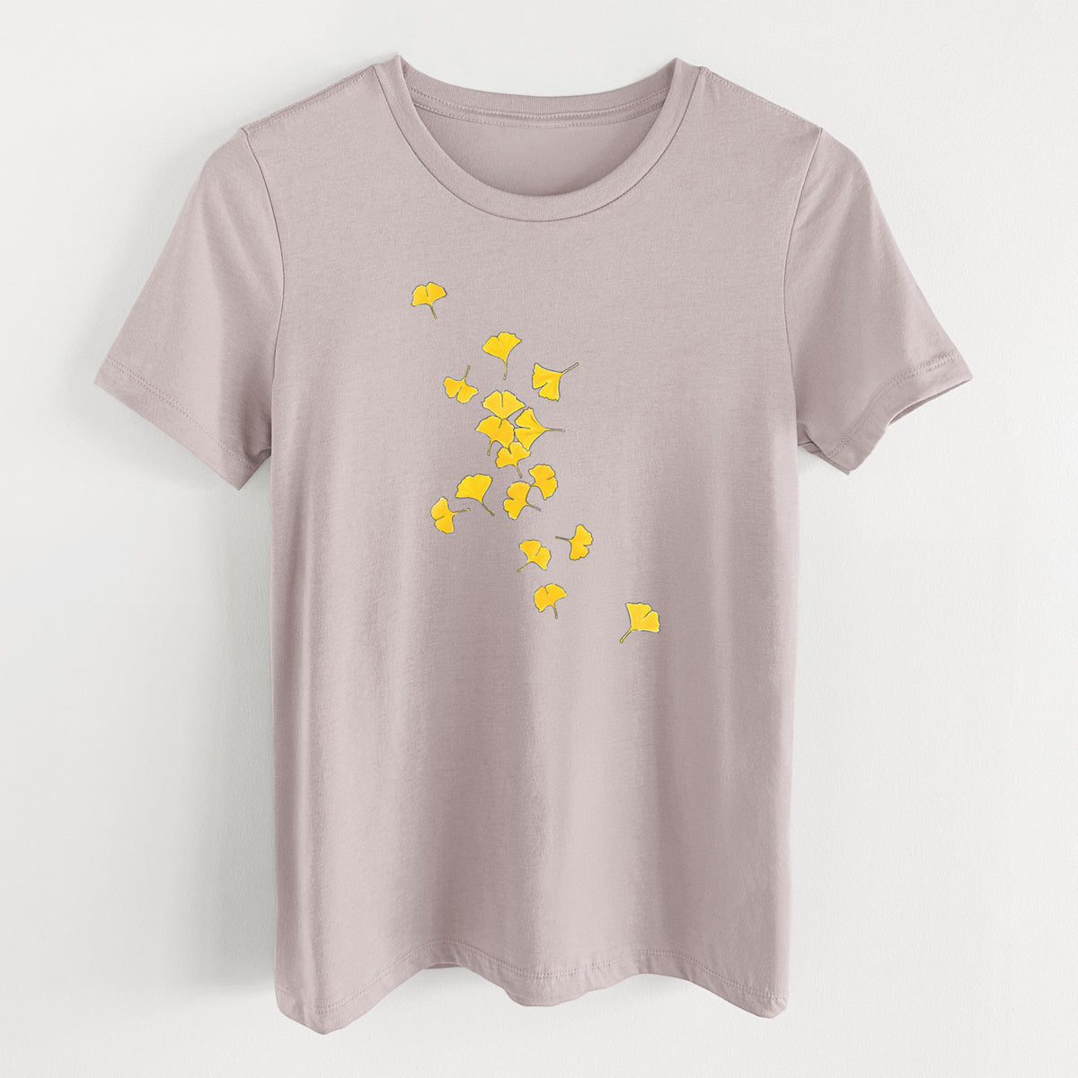 Pink gravel women's relaxed fit cotton t-shirt laid flat, printed with a scatter of bright yellow fan-shaped ginkgo leaves falling.