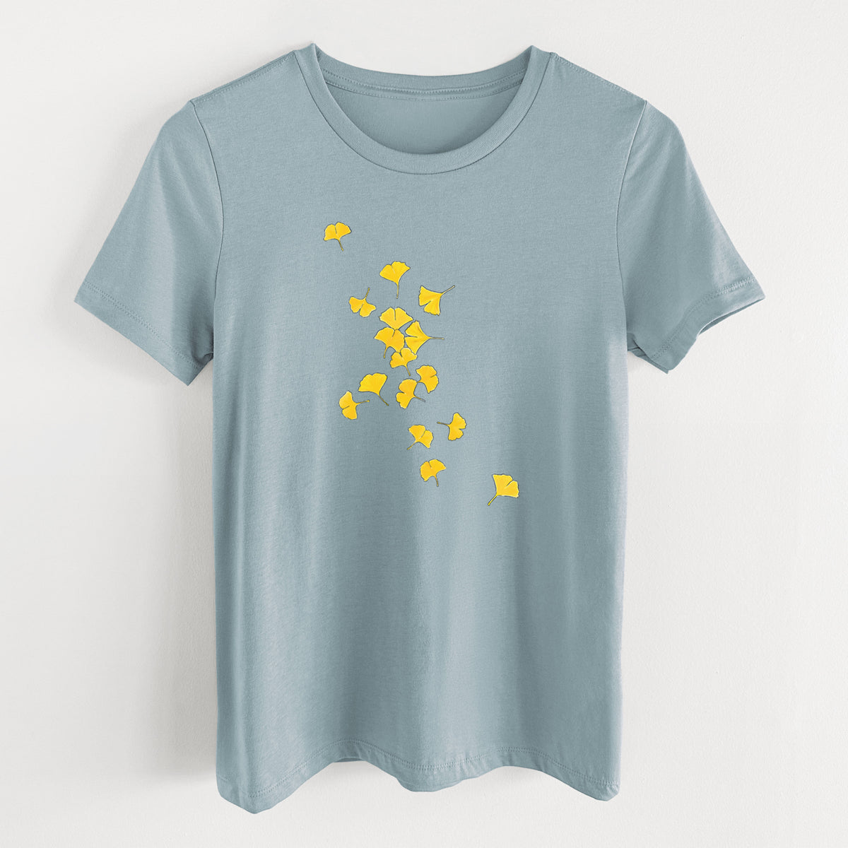 Vintage denim women's relaxed fit cotton t-shirt laid flat, printed with a scatter of bright yellow fan-shaped ginkgo leaves falling.