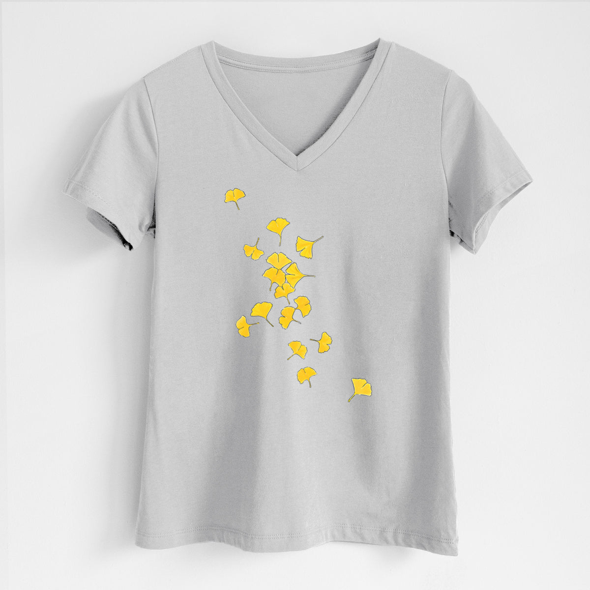Lunar grey women's relaxed fit cotton V-neck t-shirt laid flat, printed with a scatter of bright yellow fan-shaped ginkgo leaves falling.