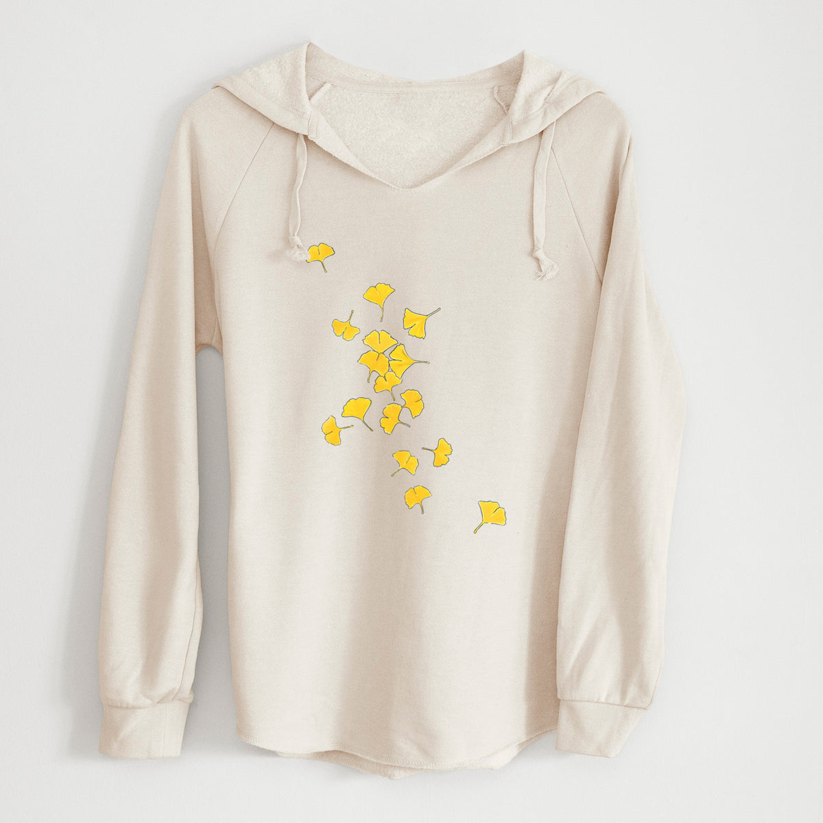 Bone cream women's Cali Wave hooded sweatshirt laid flat, printed with a scatter of bright yellow fan-shaped ginkgo leaves falling.