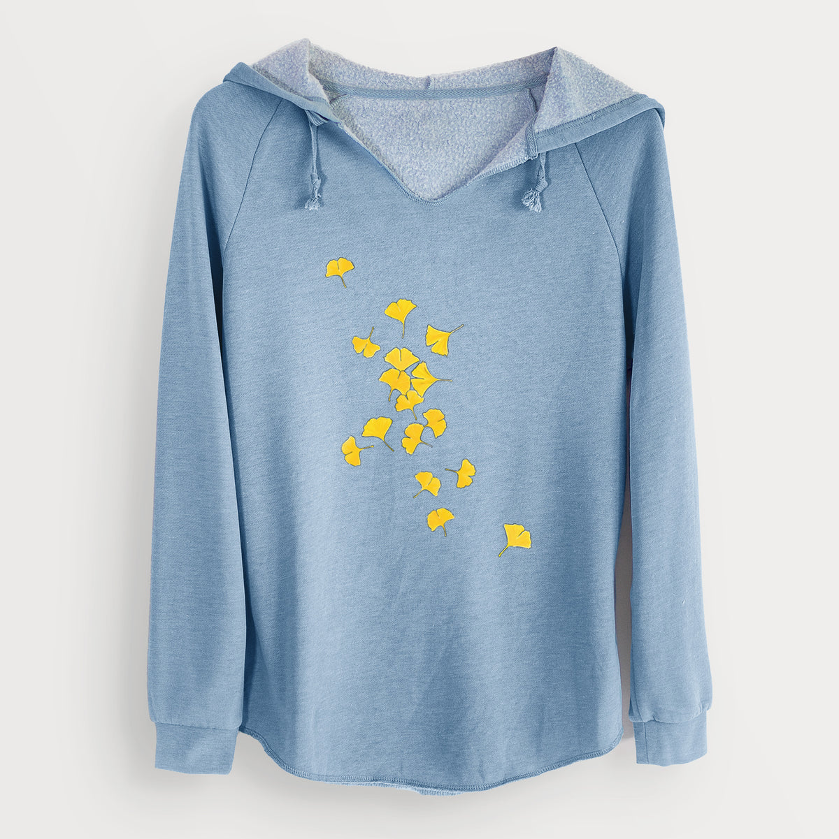 Misty blue women's Cali Wave hooded sweatshirt laid flat, printed with a scatter of bright yellow fan-shaped ginkgo leaves falling.