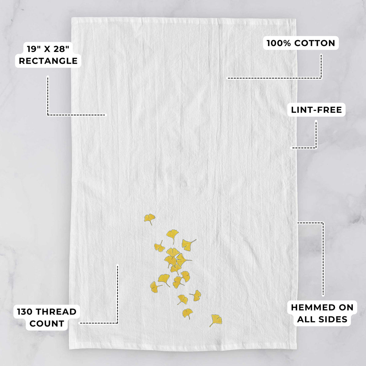 White tea towel printed with a scatter of bright yellow fan-shaped ginkgo leaves falling, with feature labels: 19 by 28 inch rectangle, 100% cotton, lint-free, 130 thread count, hemmed on all sides.