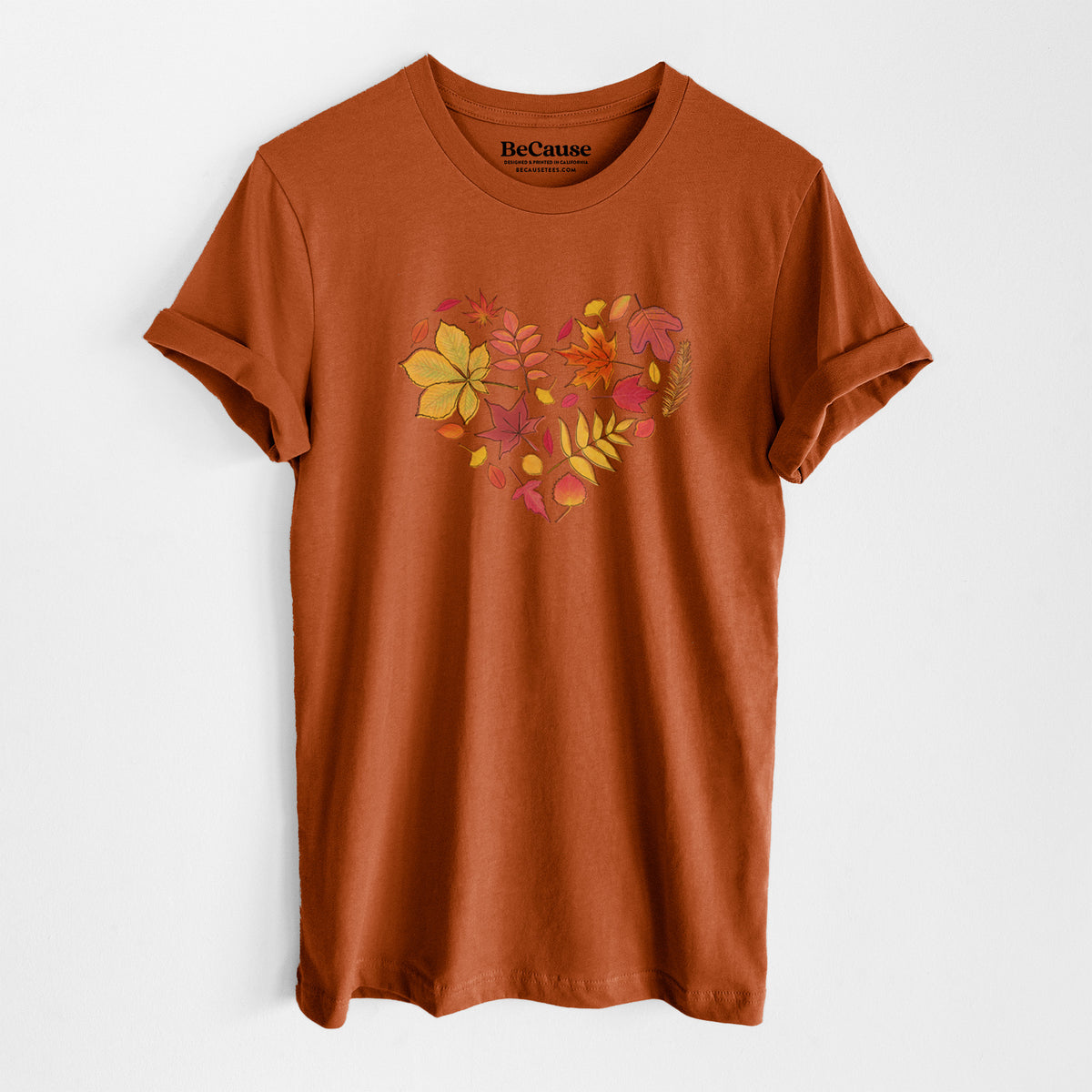 Autumn lightweight cotton t-shirt laid flat, printed with a full-color heart shape made of autumn leaves in orange, red and yellow.