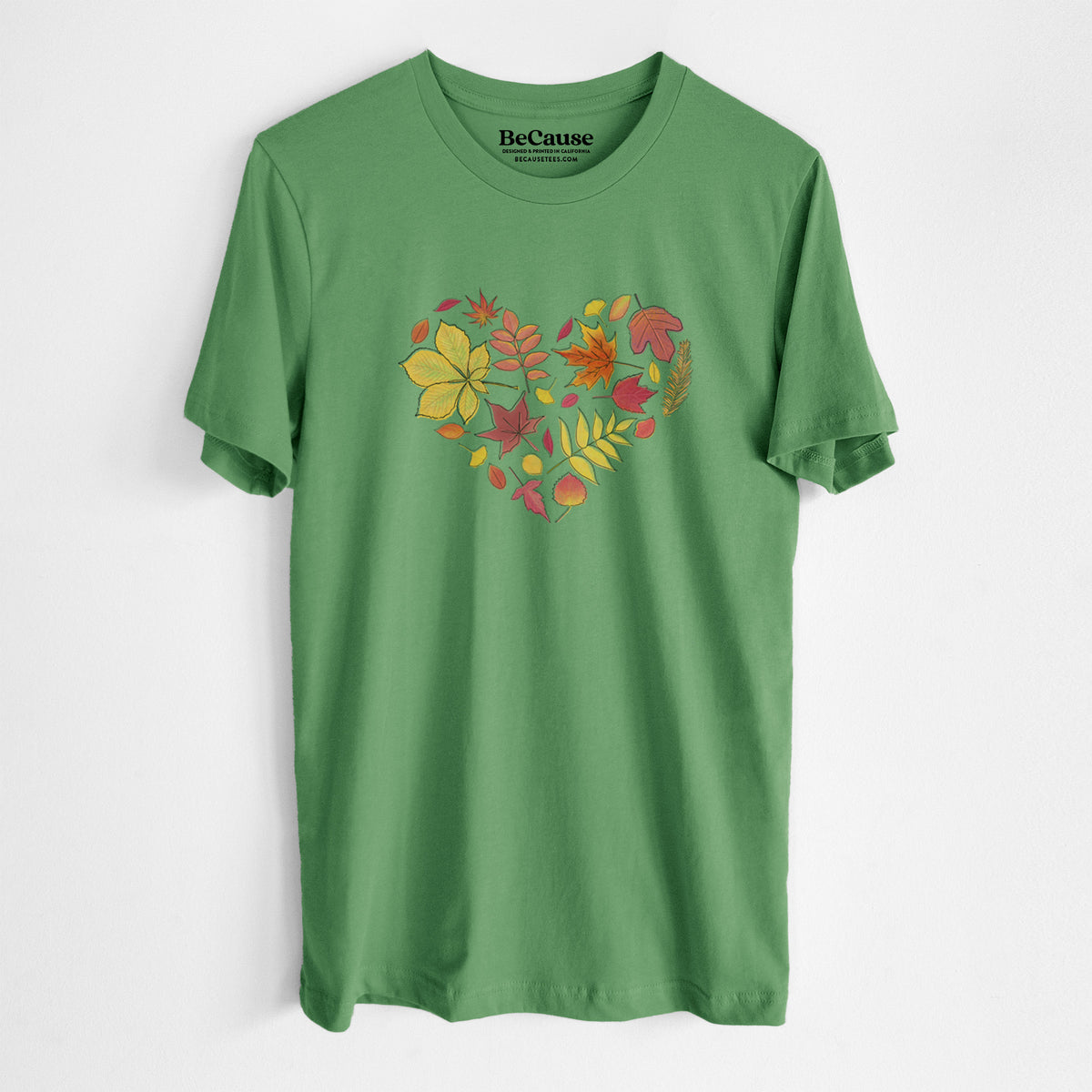 Leaf green lightweight cotton t-shirt laid flat, printed with a full-color heart shape made of autumn leaves in orange, red and yellow.