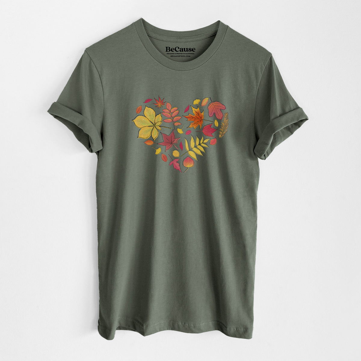 Military green lightweight cotton t-shirt laid flat, printed with a full-color heart shape made of autumn leaves in orange, red and yellow.