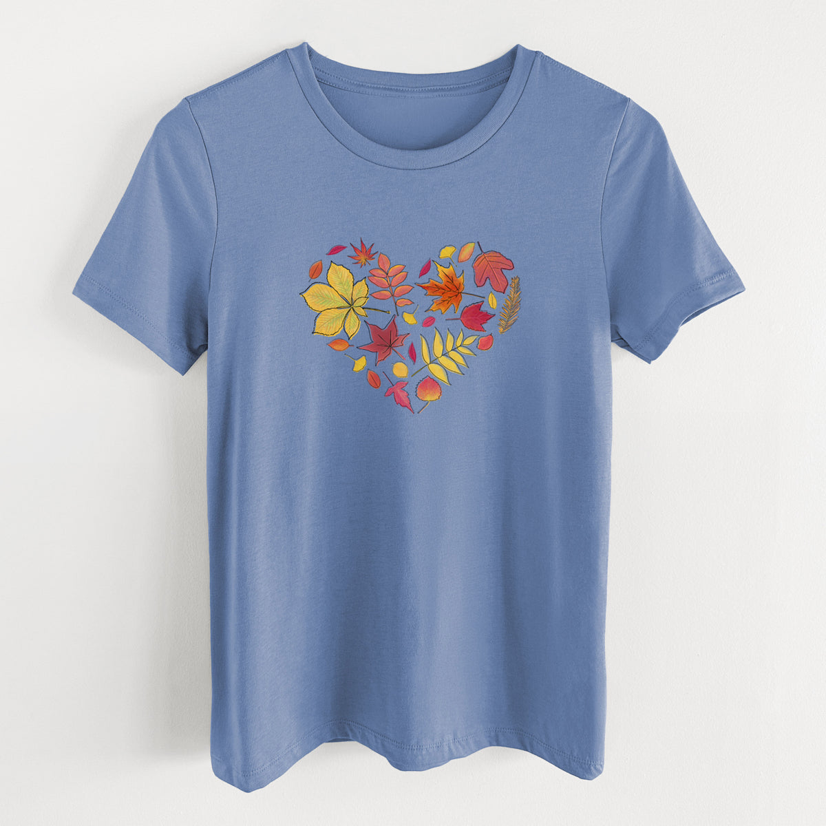 Blue bell women's relaxed fit cotton t-shirt laid flat, printed with a full-color heart shape made of autumn leaves in orange, red and yellow.