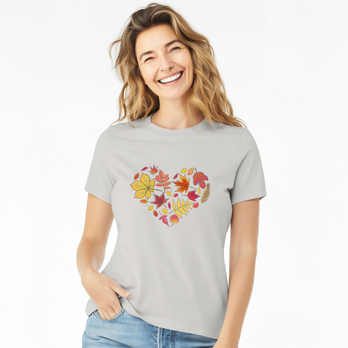 Woman wearing a lunar grey women's relaxed fit cotton t-shirt printed with a full-color heart shape made of autumn leaves in orange, red and yellow.