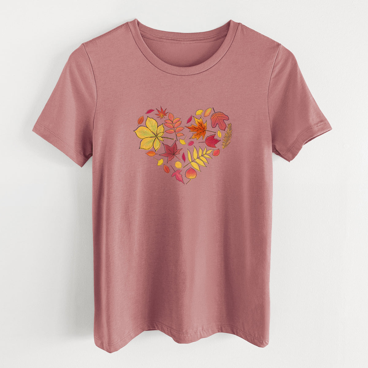 Mauve pink women's relaxed fit cotton t-shirt laid flat, printed with a full-color heart shape made of autumn leaves in orange, red and yellow.
