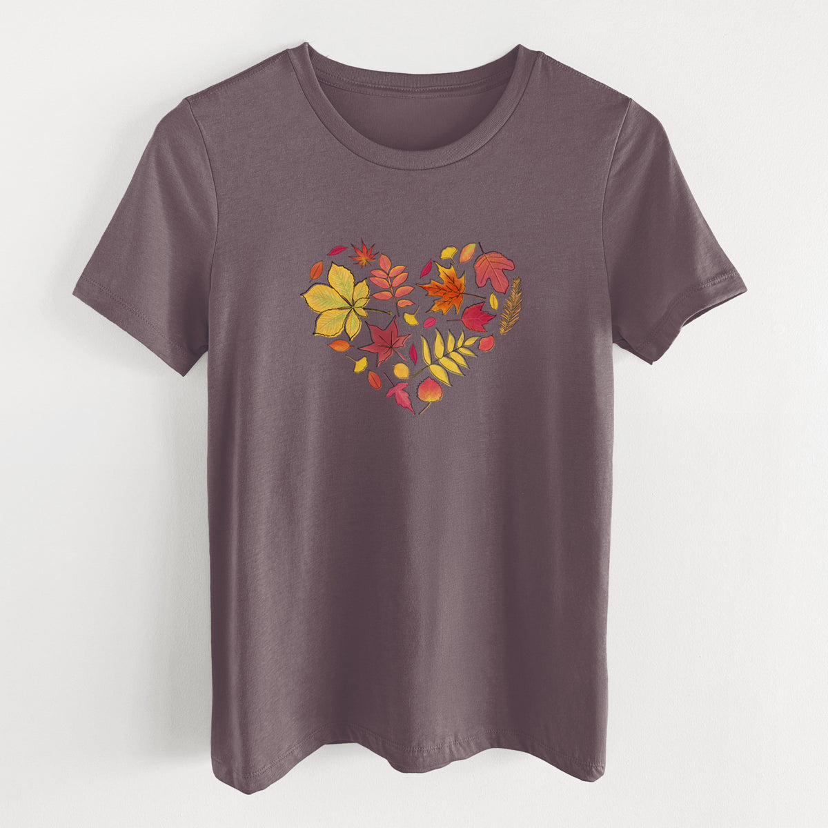 Purple storm women's relaxed fit cotton t-shirt laid flat, printed with a full-color heart shape made of autumn leaves in orange, red and yellow.
