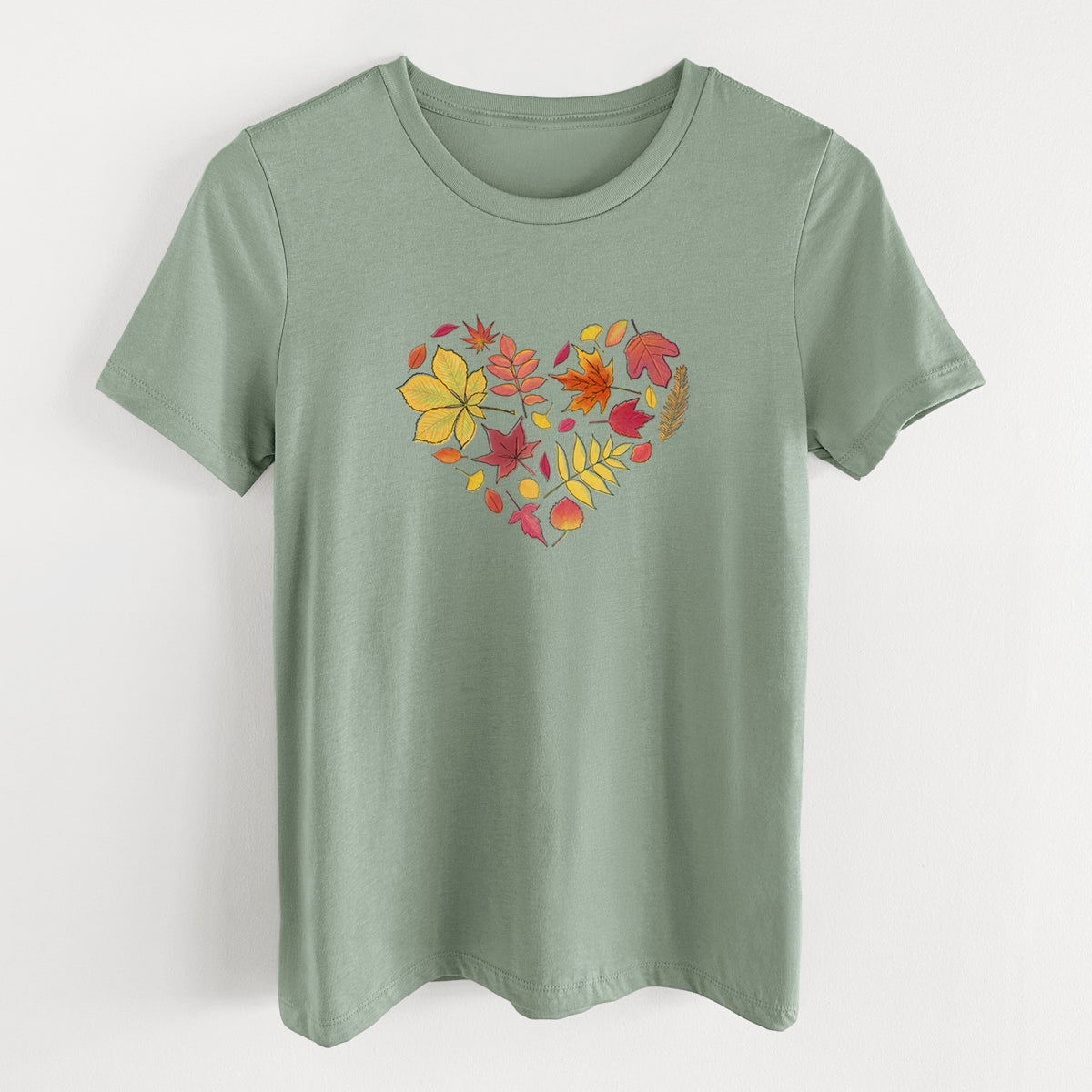 Sage green women's relaxed fit cotton t-shirt laid flat, printed with a full-color heart shape made of autumn leaves in orange, red and yellow.