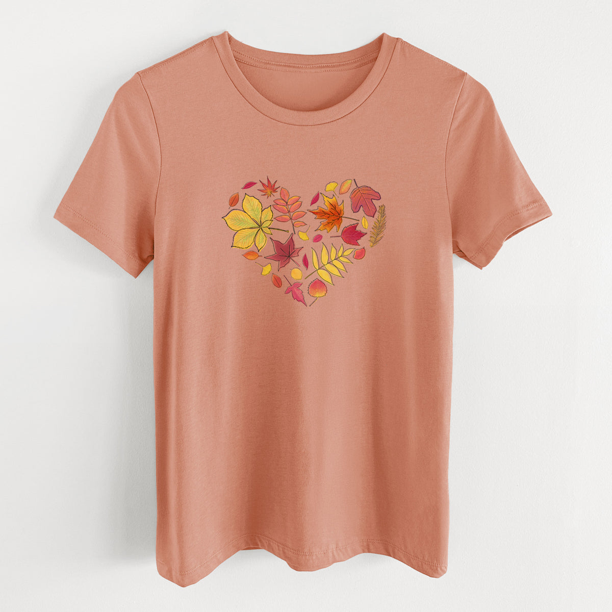 Terracotta orange women's relaxed fit cotton t-shirt laid flat, printed with a full-color heart shape made of autumn leaves in orange, red and yellow.