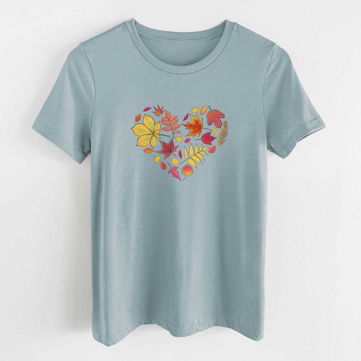 Vintage denim women's relaxed fit cotton t-shirt laid flat, printed with a full-color heart shape made of autumn leaves in orange, red and yellow.
