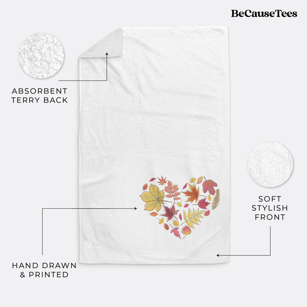 White hand towel printed with a full-color heart shape made of autumn leaves in orange, red and yellow.