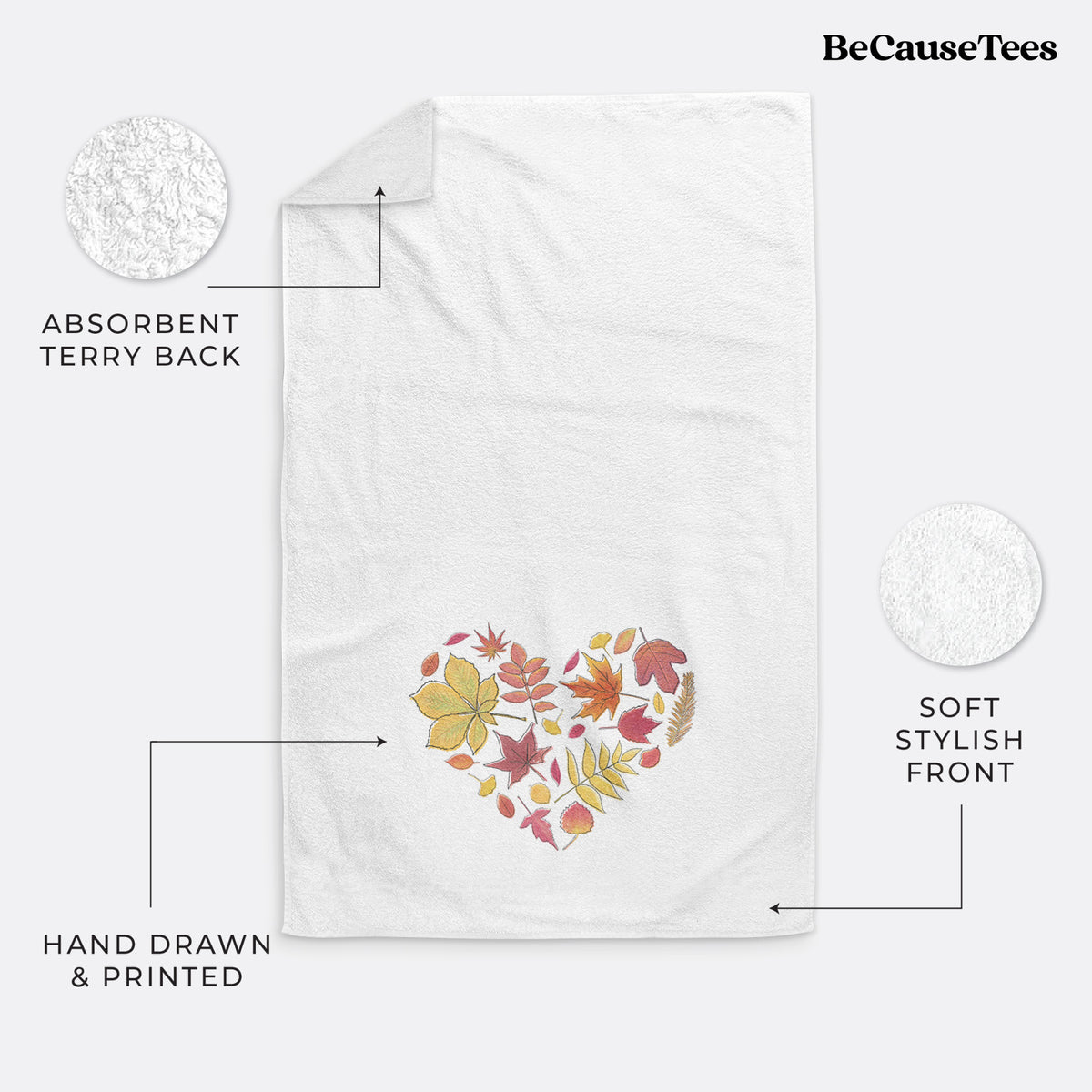 White hand towel printed with a full-color heart shape made of autumn leaves in orange, red and yellow.
