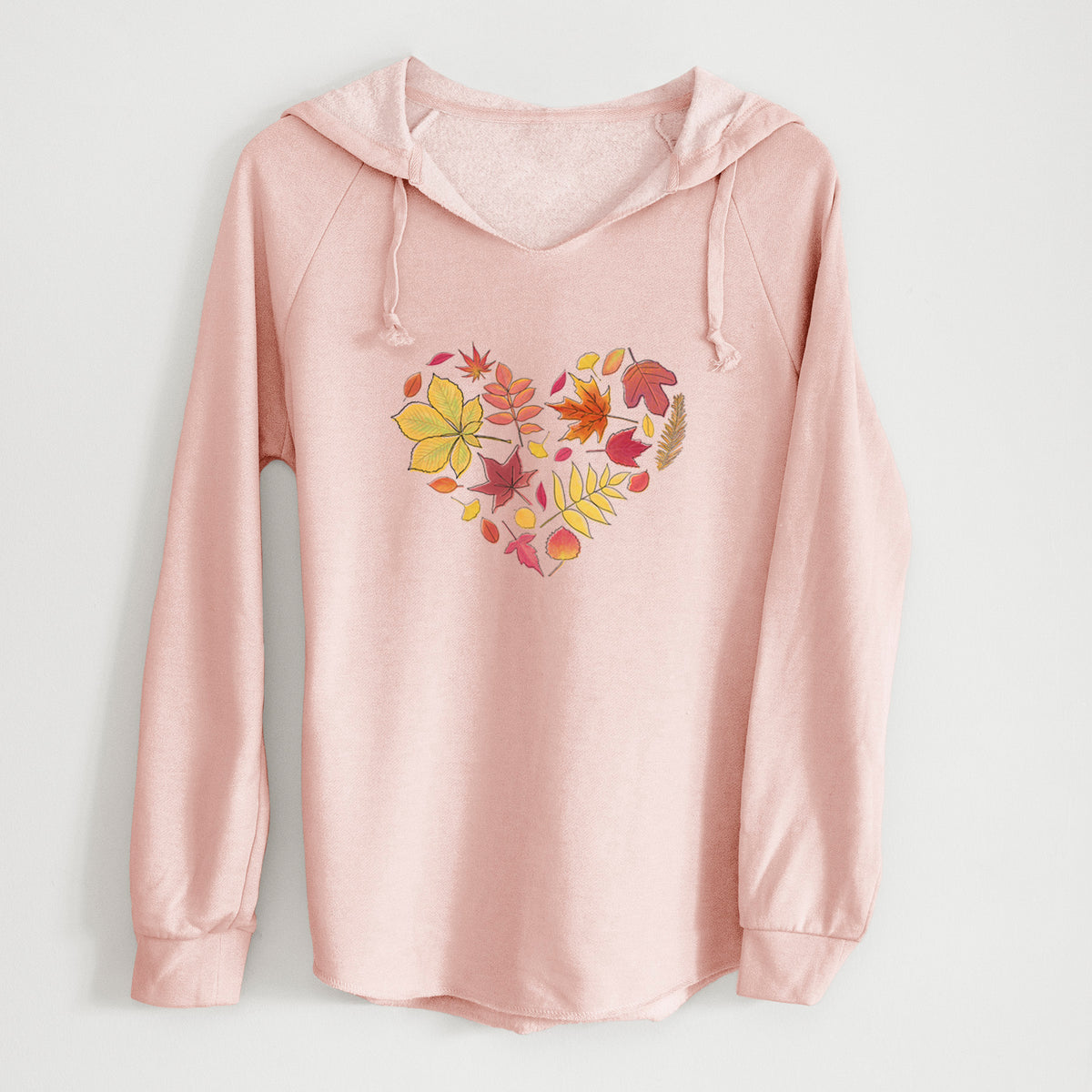 Blush pink women's Cali Wave hooded sweatshirt laid flat, printed with a full-color heart shape made of autumn leaves in orange, red and yellow.
