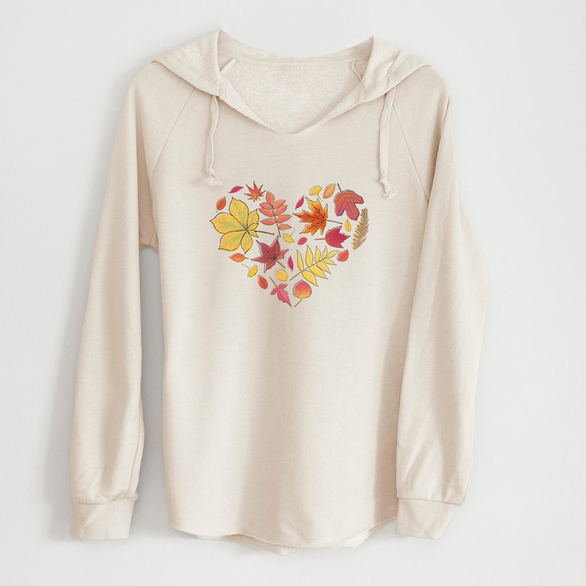 Bone cream women's Cali Wave hooded sweatshirt laid flat, printed with a full-color heart shape made of autumn leaves in orange, red and yellow.
