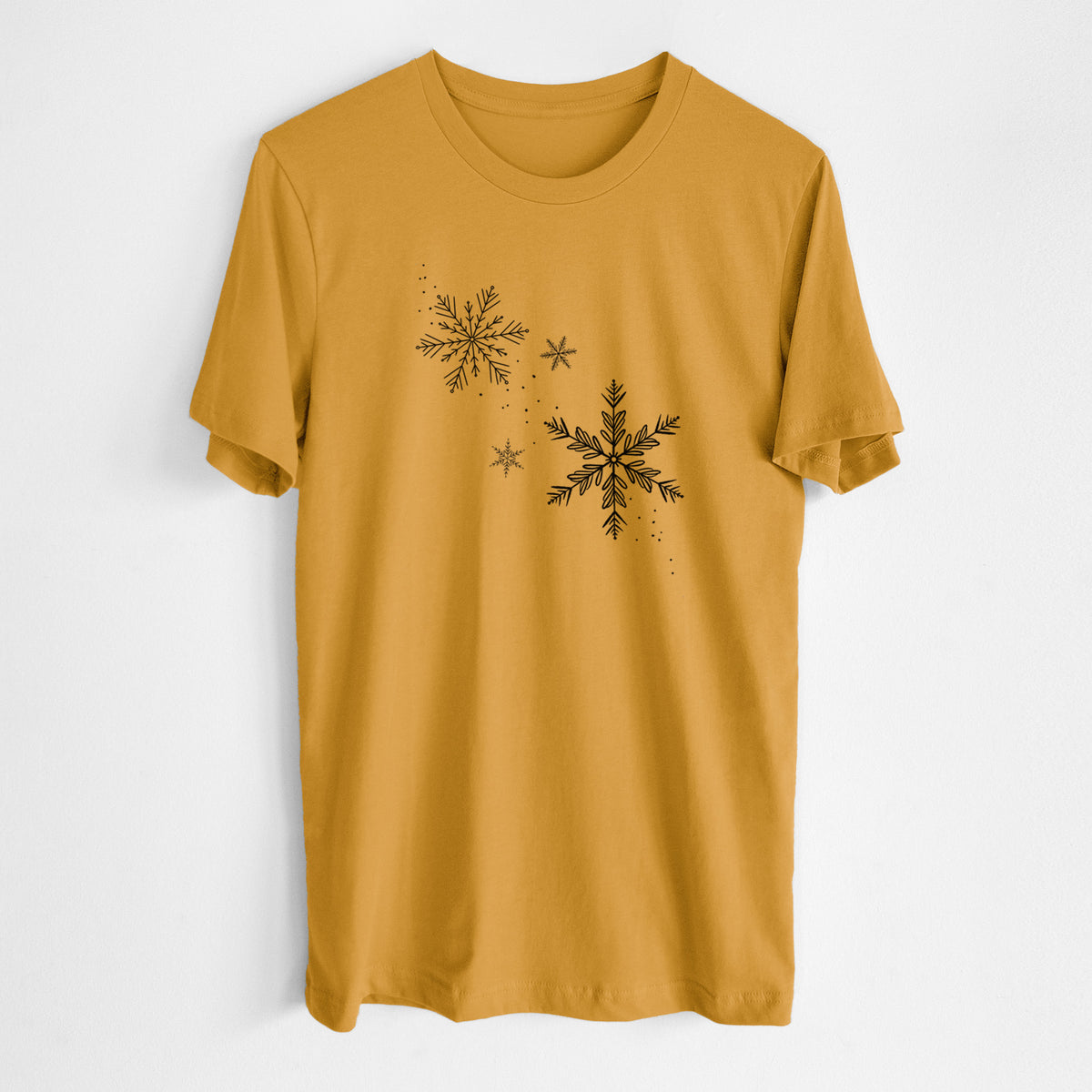 Honeycomb yellow lightweight cotton t-shirt laid flat, printed with delicate snowflakes of different sizes falling.