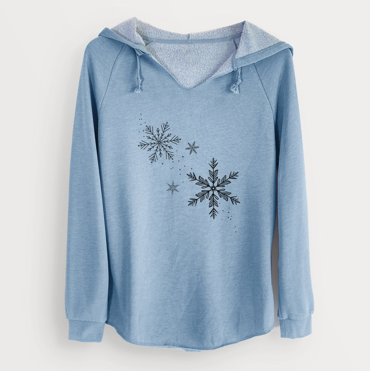 Misty blue women's Cali Wave hooded sweatshirt laid flat, printed with delicate snowflakes of different sizes falling.