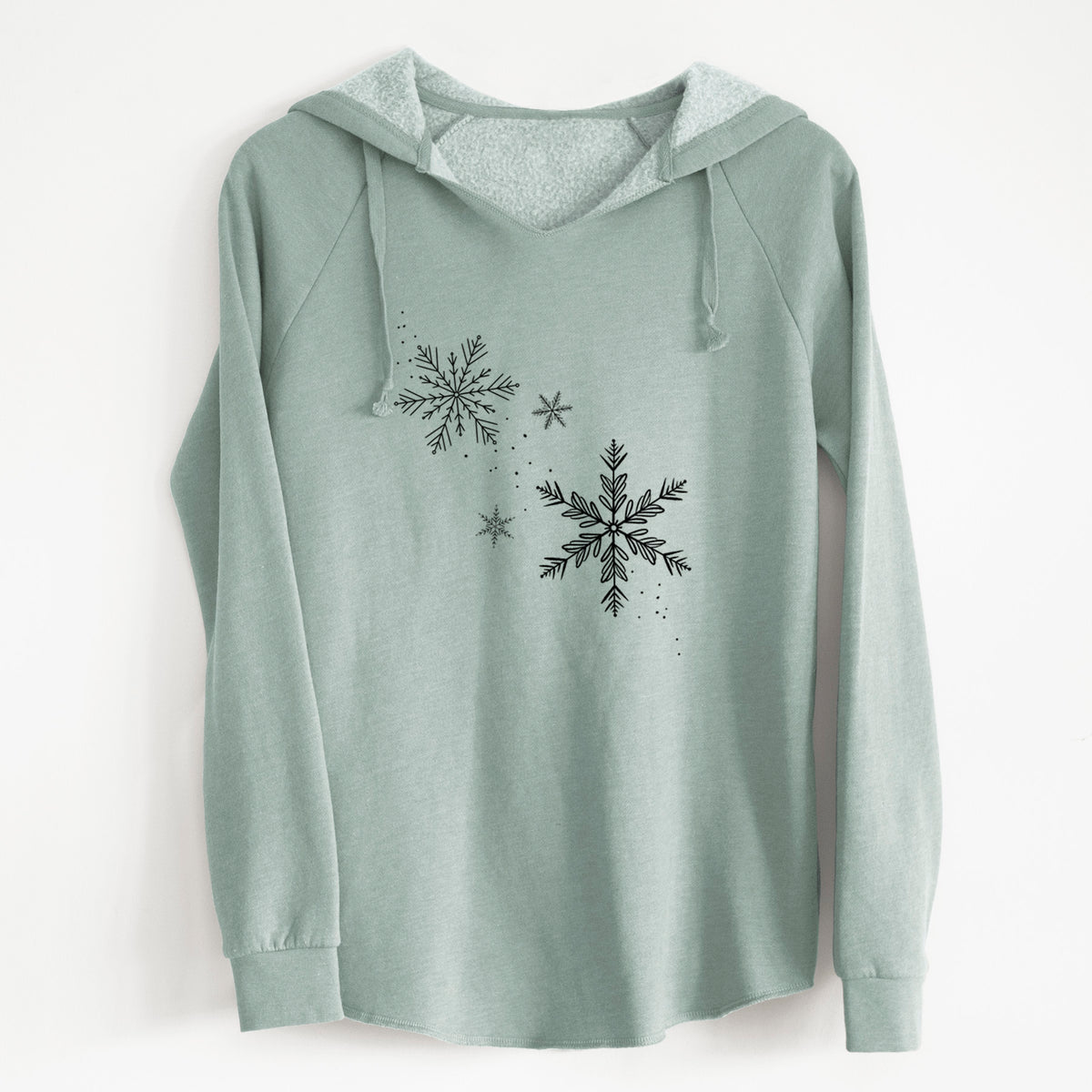 Sage green women's Cali Wave hooded sweatshirt laid flat, printed with delicate snowflakes of different sizes falling.