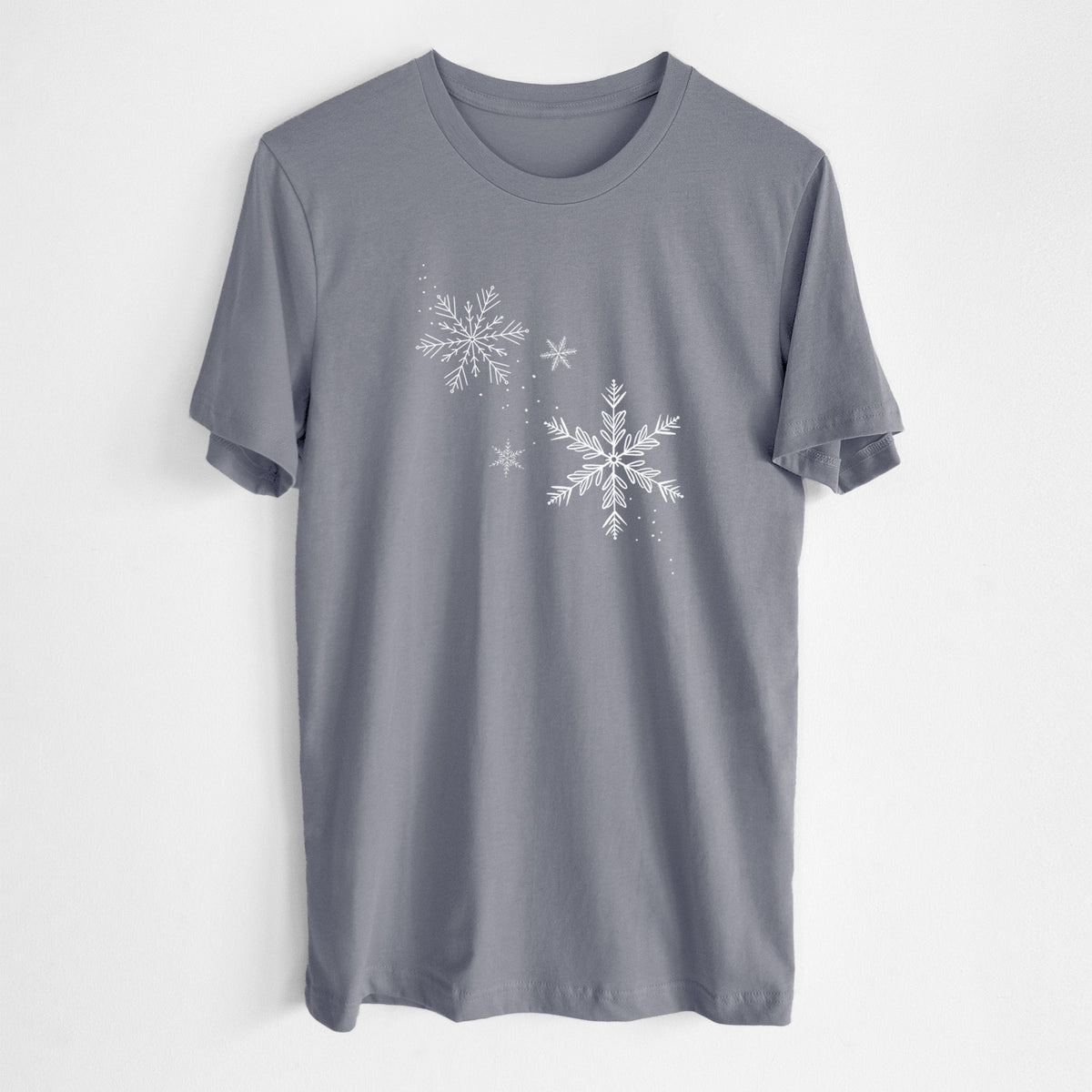 Storm grey lightweight cotton t-shirt laid flat, printed with delicate white snowflakes of different sizes falling.