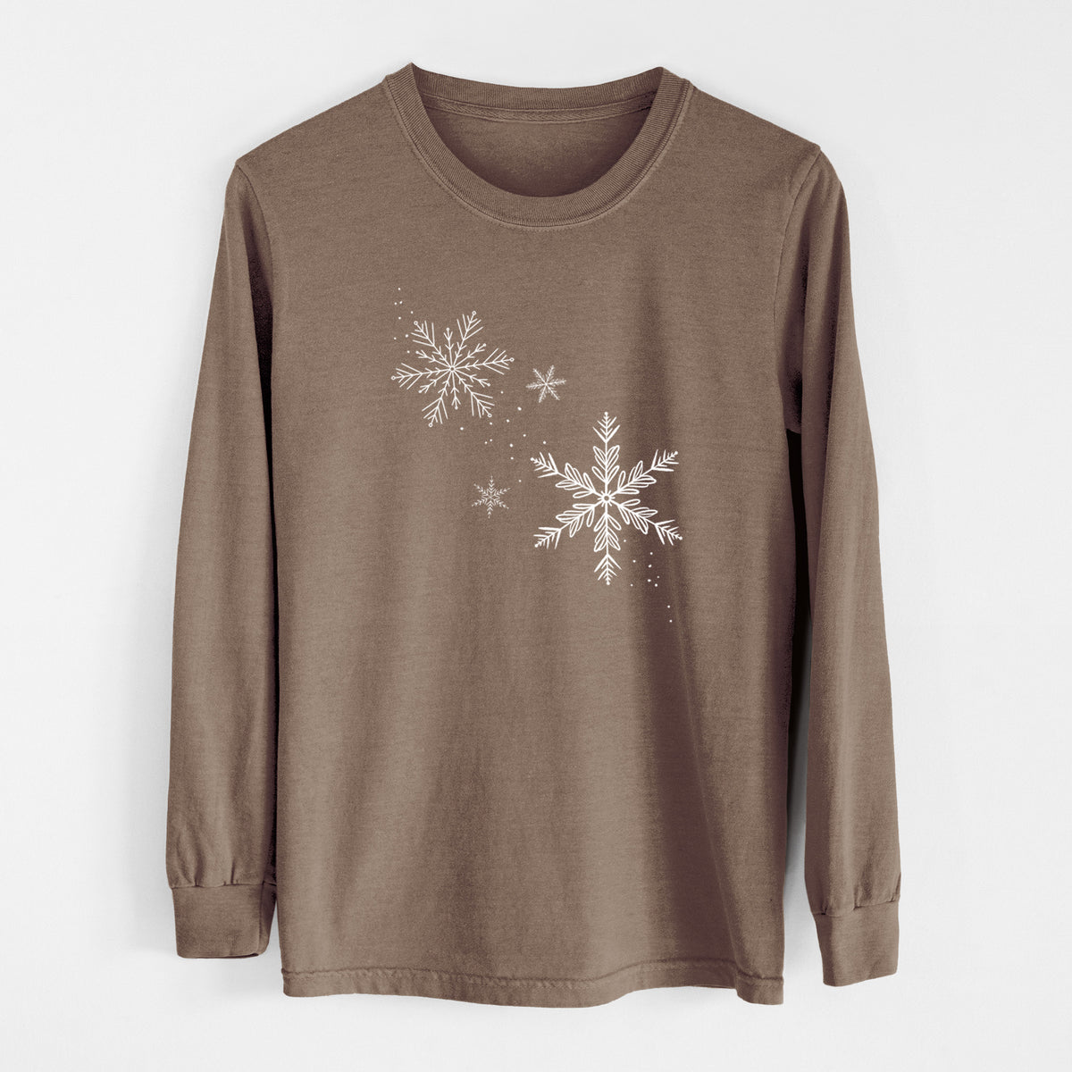 Espresso brown Comfort Colors long sleeve shirt laid flat, printed with delicate white snowflakes of different sizes falling.