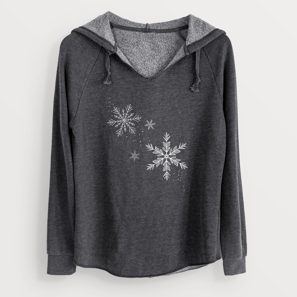 Charcoal grey women's Cali Wave hooded sweatshirt laid flat, printed with delicate white snowflakes of different sizes falling.
