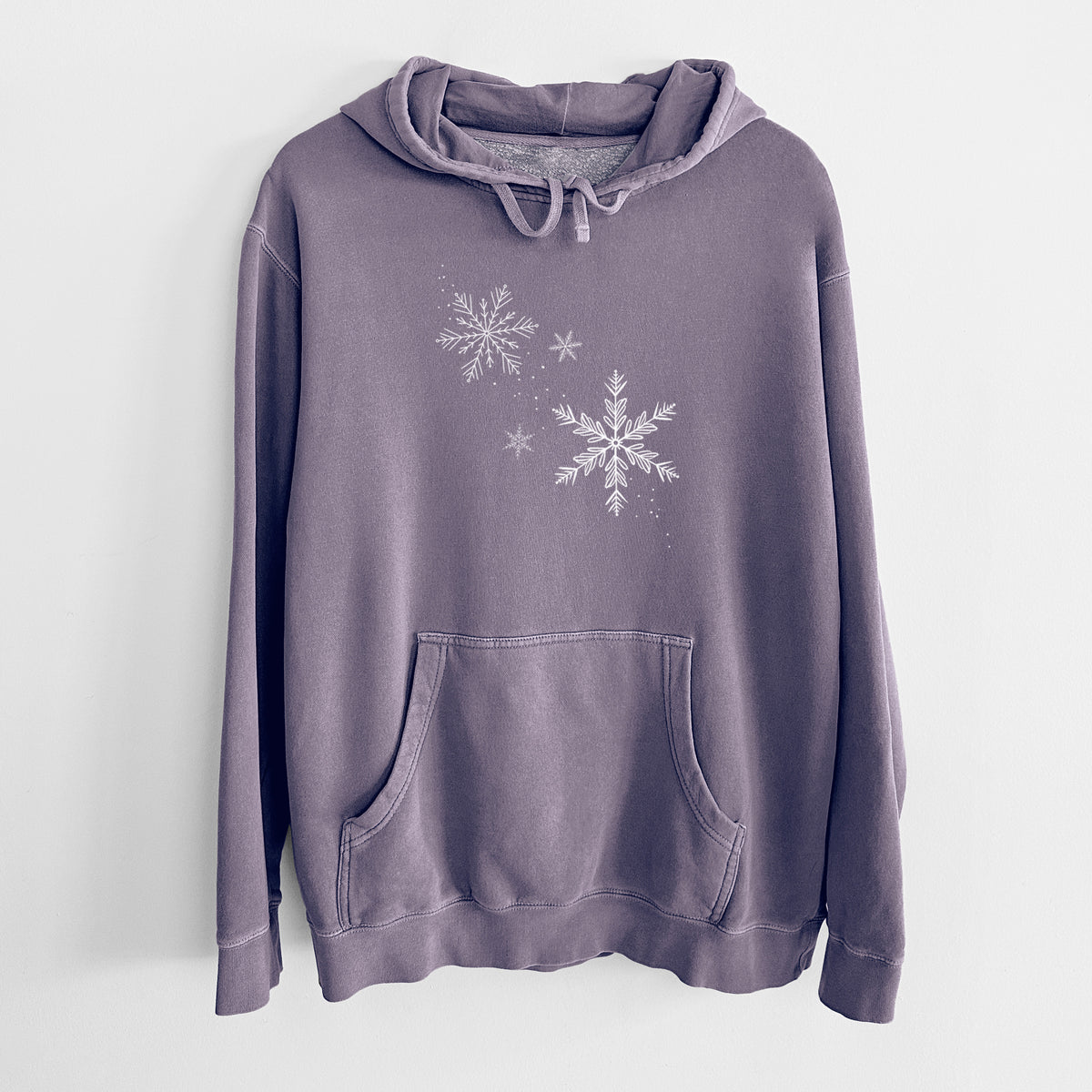 Plum purple pigment dyed hoodie laid flat, printed with delicate white snowflakes of different sizes falling.