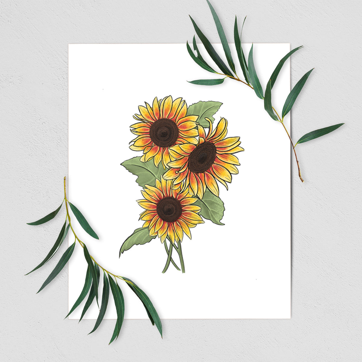 Art print of a full-color illustration of a bunch of yellow and orange sunflowers, shown with eucalyptus leaves.