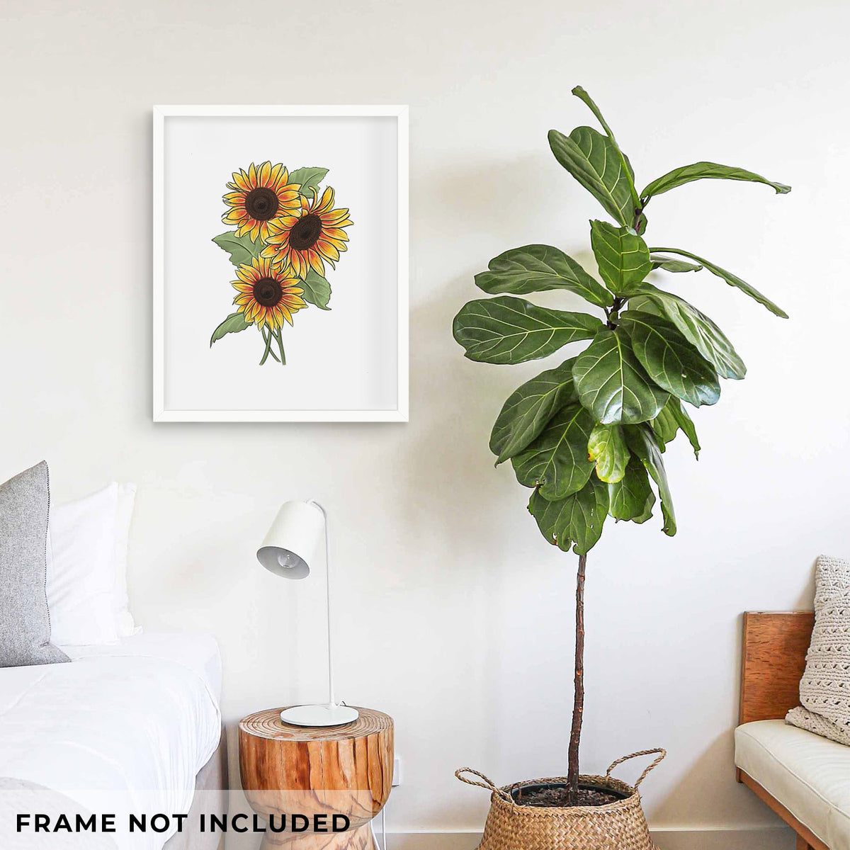 Art print of a full-color illustration of a bunch of yellow and orange sunflowers, shown framed on a living room wall beside a potted plant. Frame not included.